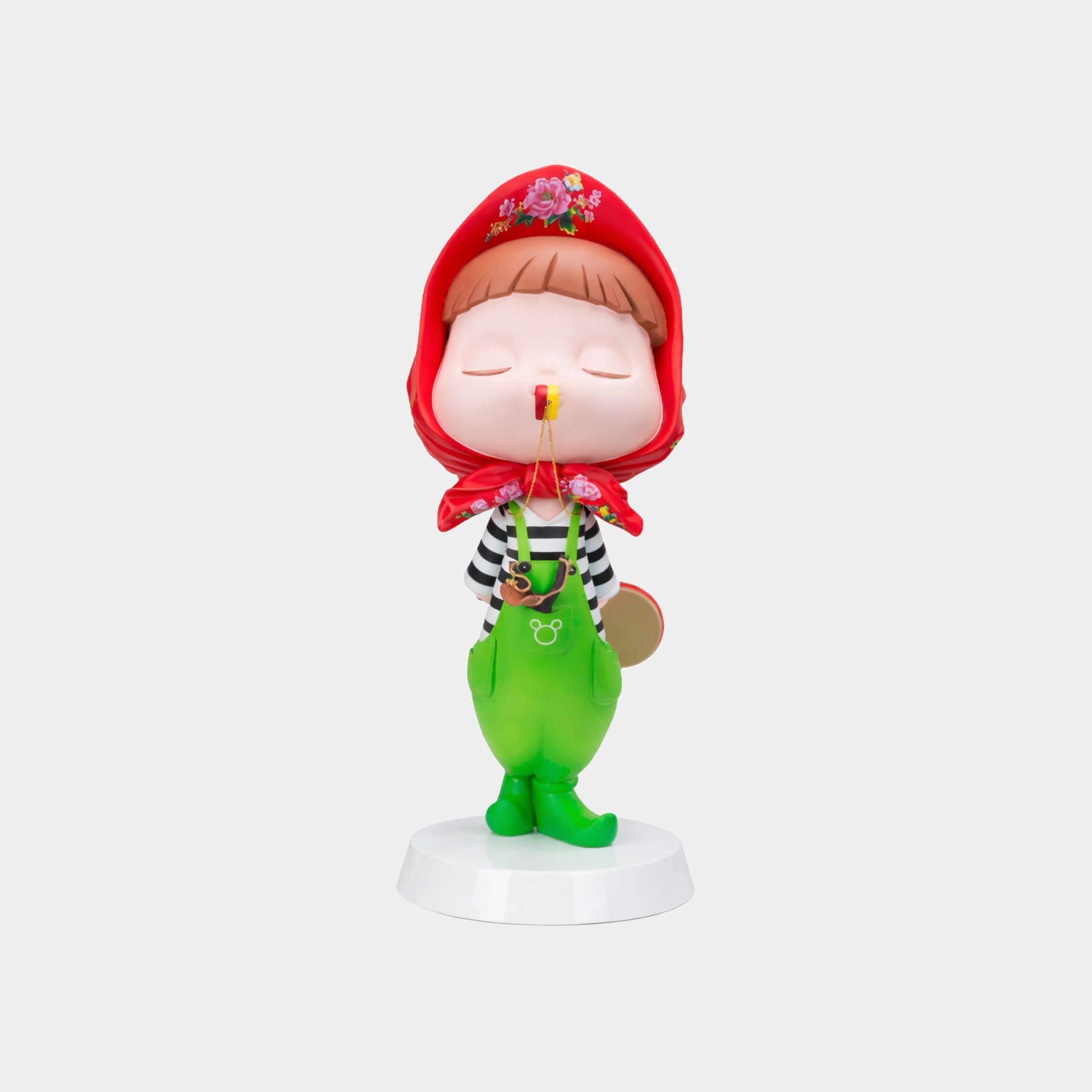The Scarlet Green Puffelle Sculpture - 68cm by Giant Sculptures displays a whimsical child in a red floral scarf, green overalls, and boots, cradling a flower—an eco-friendly decor piece for playful spaces.