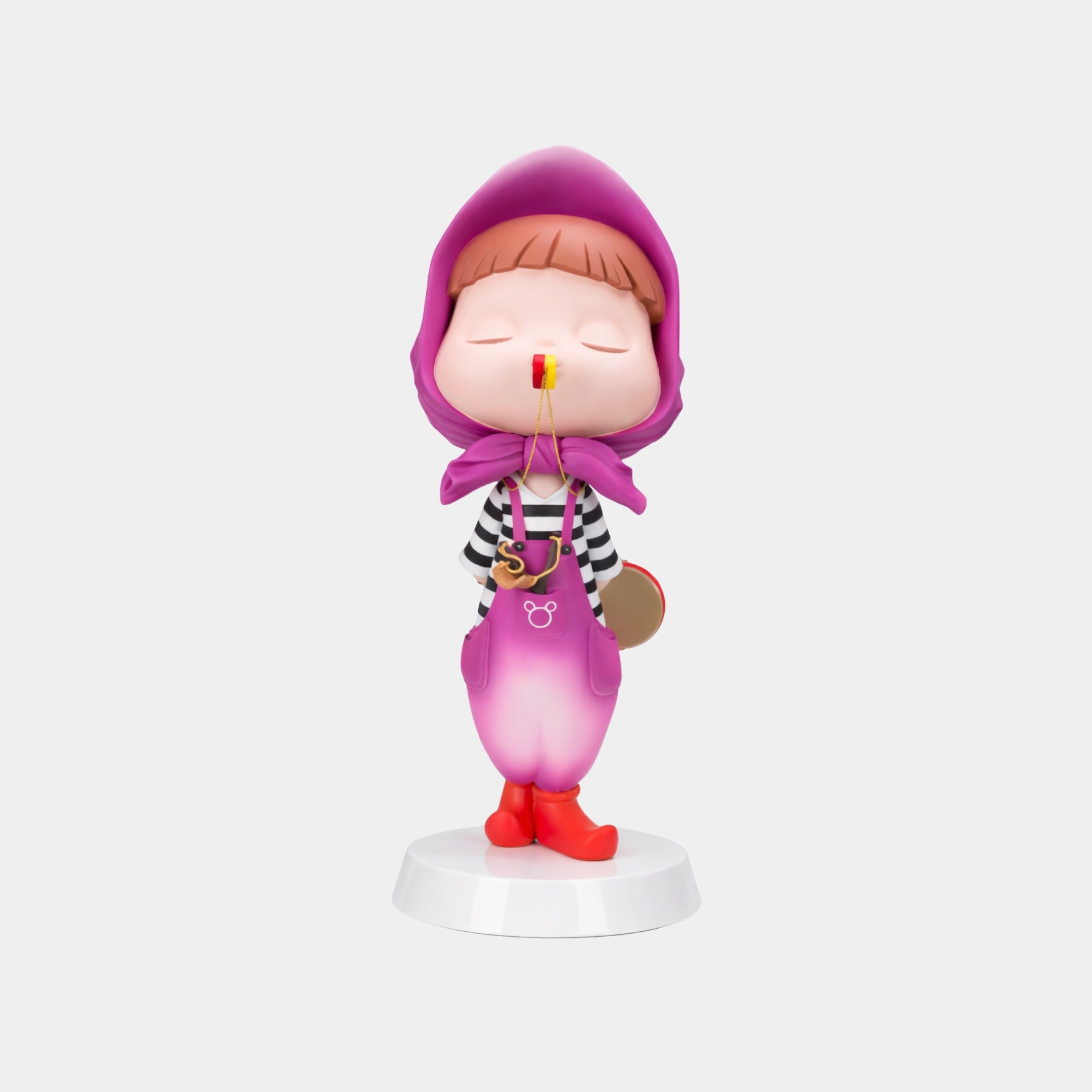 The Orchid Purple Puffelle Sculpture (68cm) by Giant Sculptures features a child in a purple hood and pink overalls, eyes closed, holding a red lollipop—an adorable decorative piece for modern interiors.