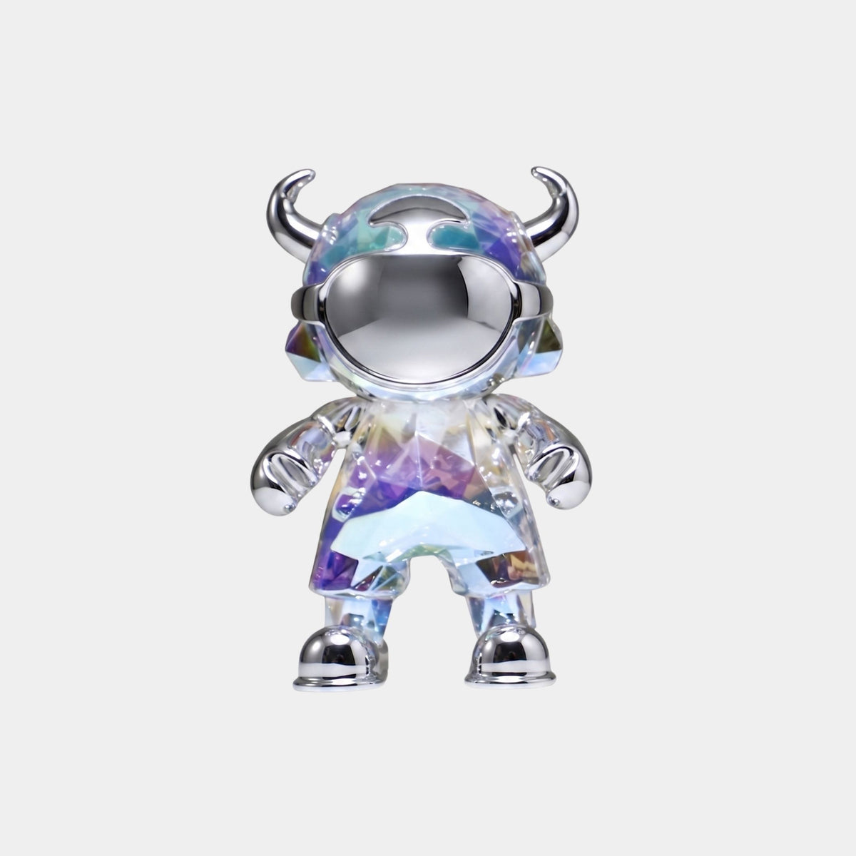 The Chrome Prism Astro Devil Figure (21cm) by Giant Sculptures features a faceted, iridescent chrome body with a horned helmet, large visor, metallic hands, shoes, and accents—displayed on a plain light background.
