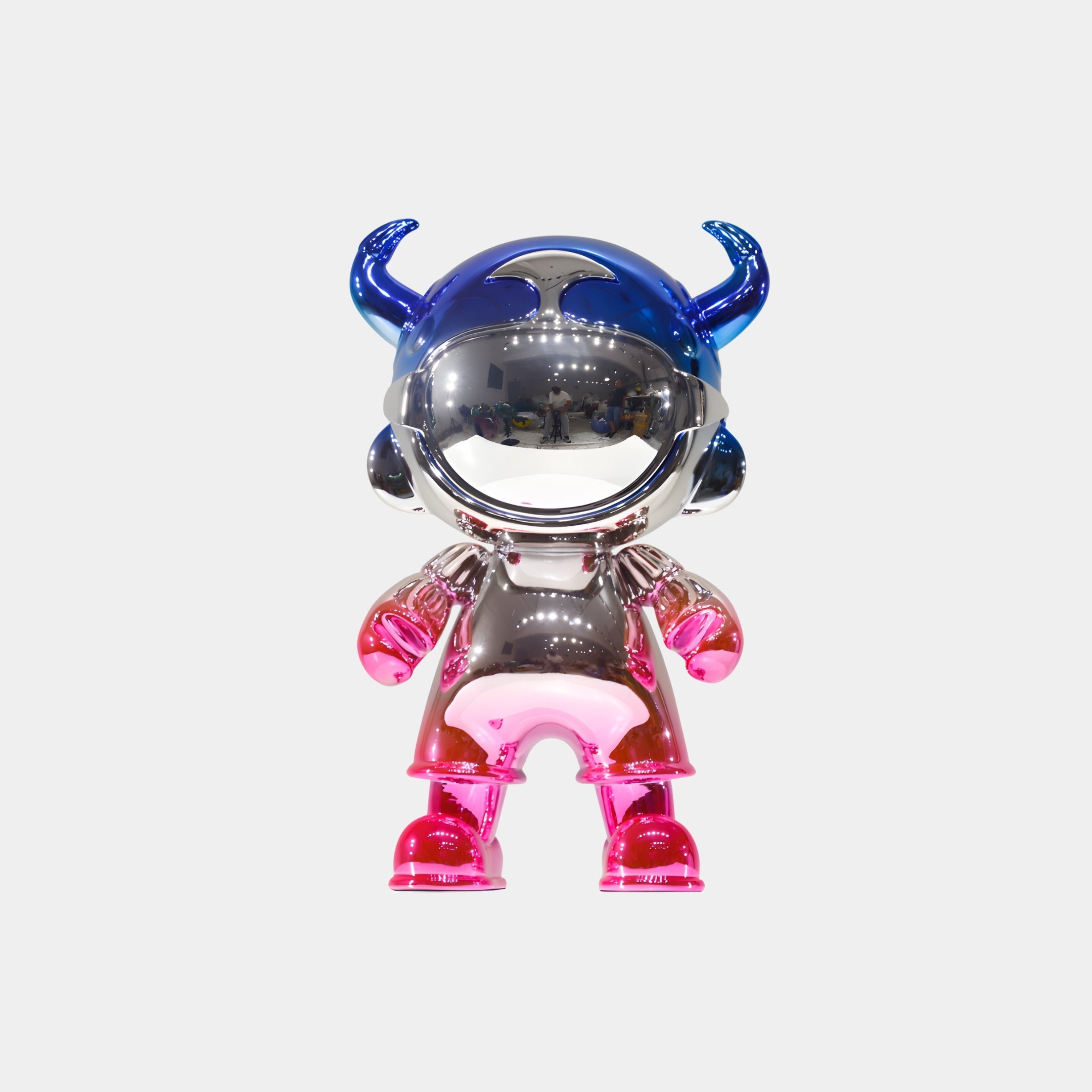 The Giant Sculptures Royal Blue & Pink Electroplated Astro Devil Figure (35cm) features a shiny metallic finish, large mirrored visor, blue horned helmet, and pink arms and legs, displayed against a plain white background.