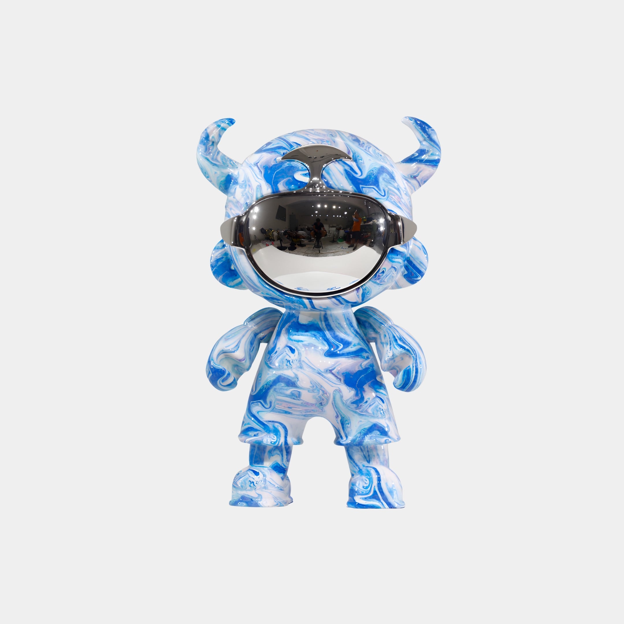 The Ocean Camo Astro Devil Figure - 35cm by Giant Sculptures features a blue and white marbled design, horn-like head shapes, and a shiny visor helmet covering its eyes, displayed on a plain white background.
