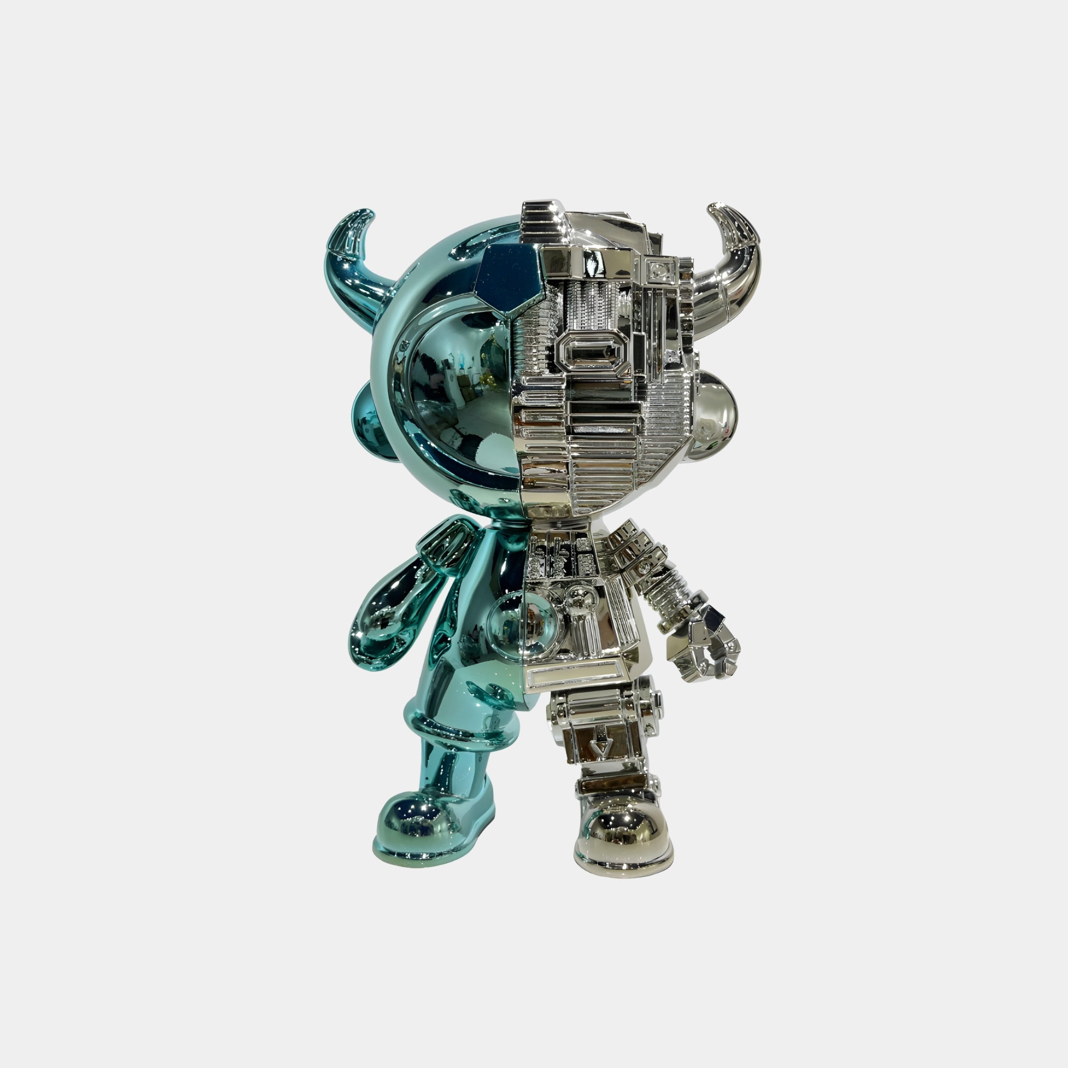 The Teal & Silver Split Astro Devil Figure - 35cm by Giant Sculptures features a shiny finish with one teal, smooth half and one silver, mechanical half with horns—a striking collectible sculpture for any display.