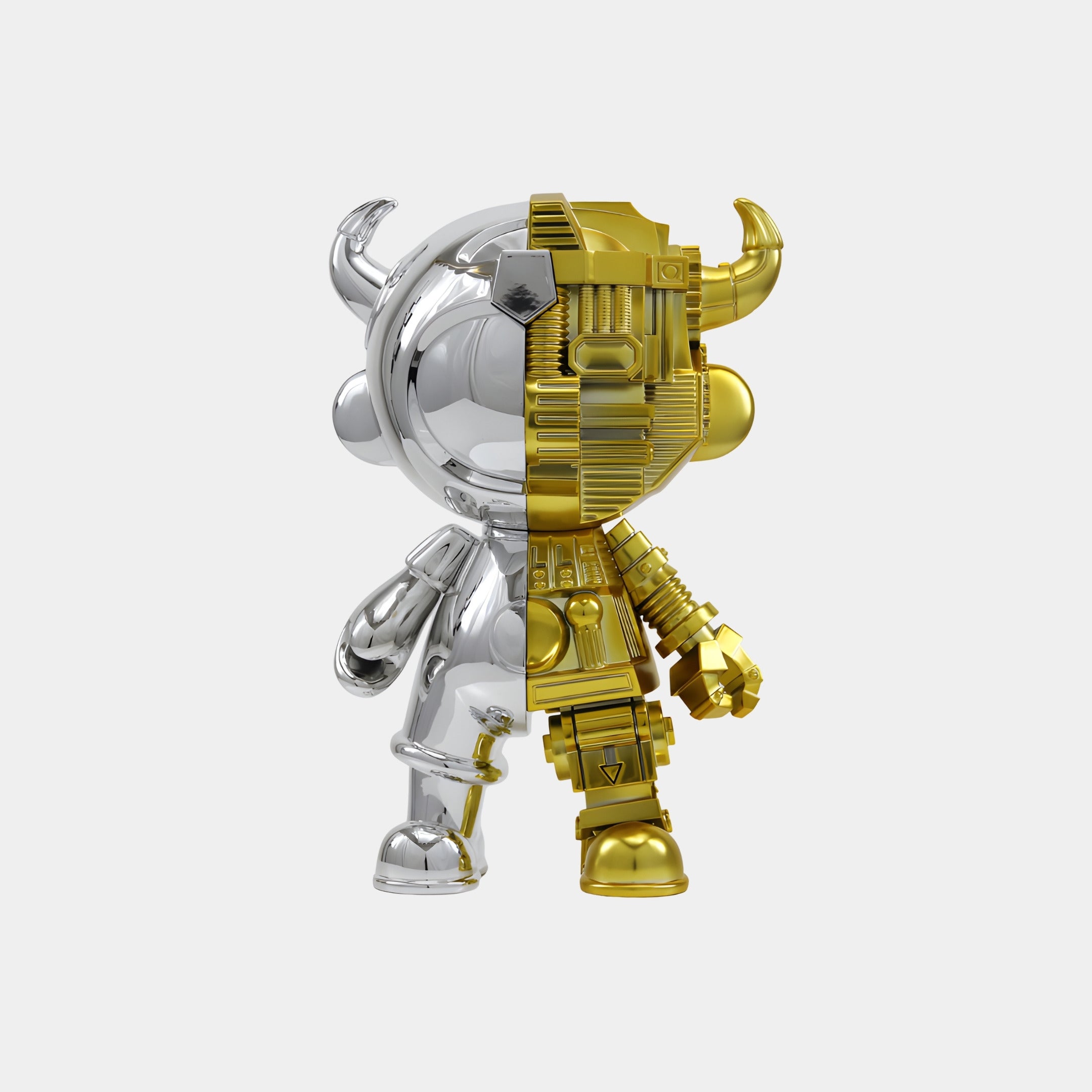 The Giant Sculptures Silver & Gold Split Astro Devil Figure - 35cm features a vertical split: one side smooth silver with a horned helmet, the other gold with a mechanical texture. Made from eco-friendly resin and shown on a plain white background.