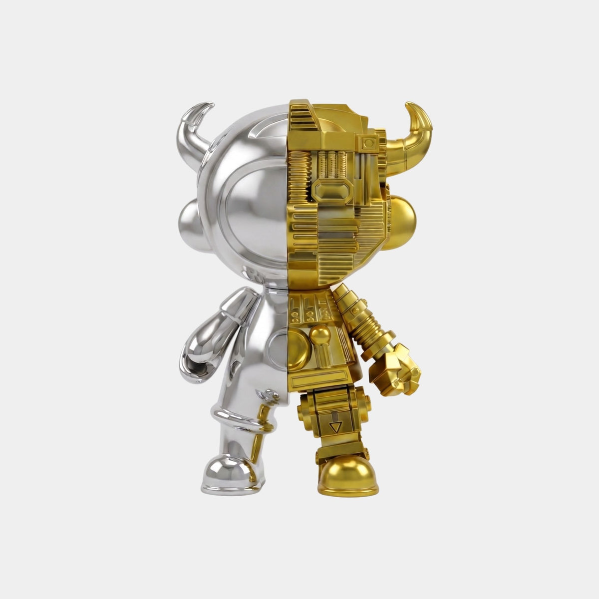 The Giant Sculptures Silver & Gold Split Astro Devil Figure - 35cm features a vertical split: one side smooth silver with a horned helmet, the other gold with a mechanical texture. Made from eco-friendly resin and shown on a plain white background.