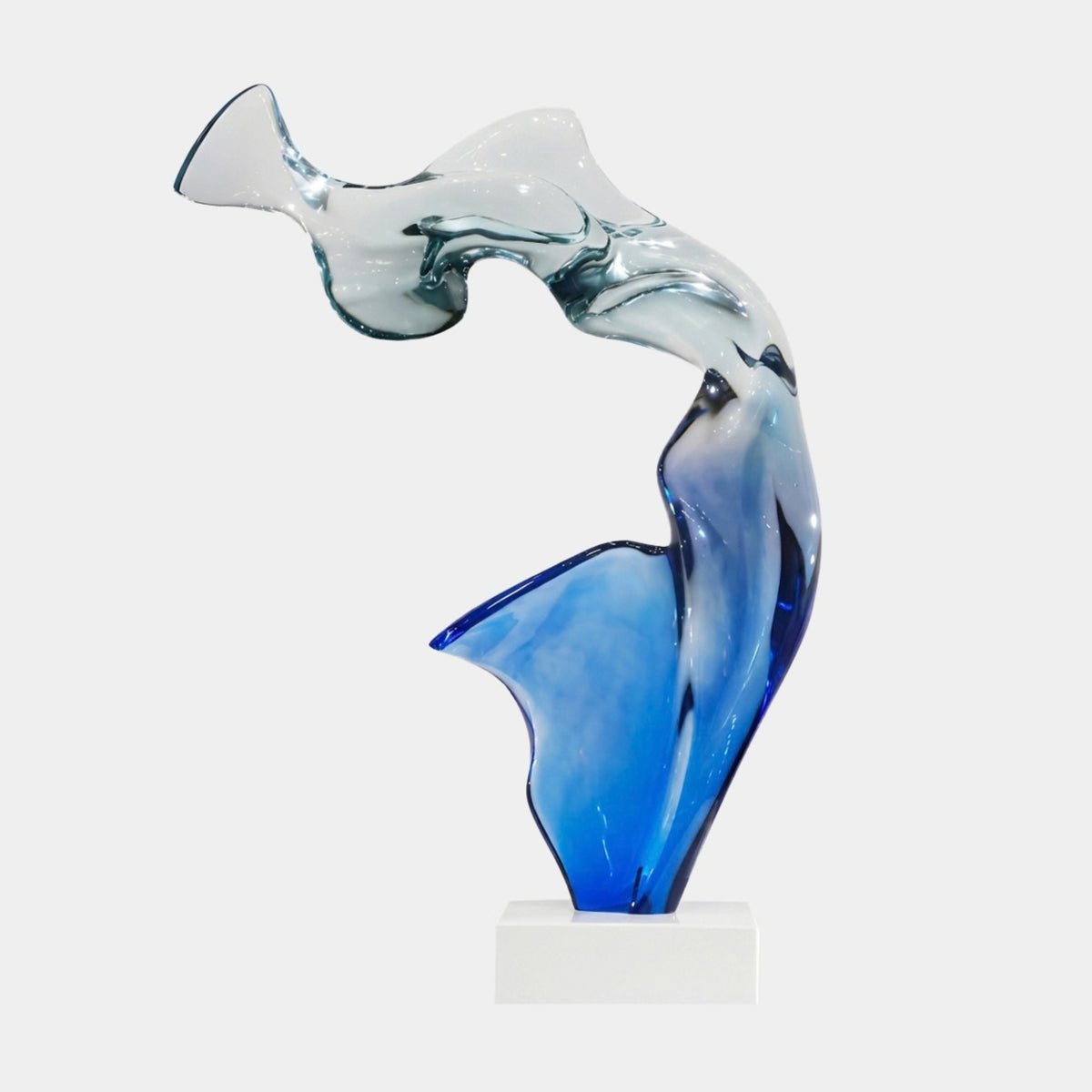 Clear & Blue Arched Abstract Resin Sculpture, 97cm, with blue pooling at the base and fin fading into a clear arched top, on a white block base against a white background.