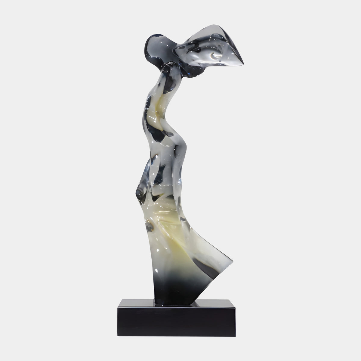 Black & Cream Windblown Figure Resin Sculpture, 68cm, abstract windswept form on a black marble base, set against a plain light grey background.