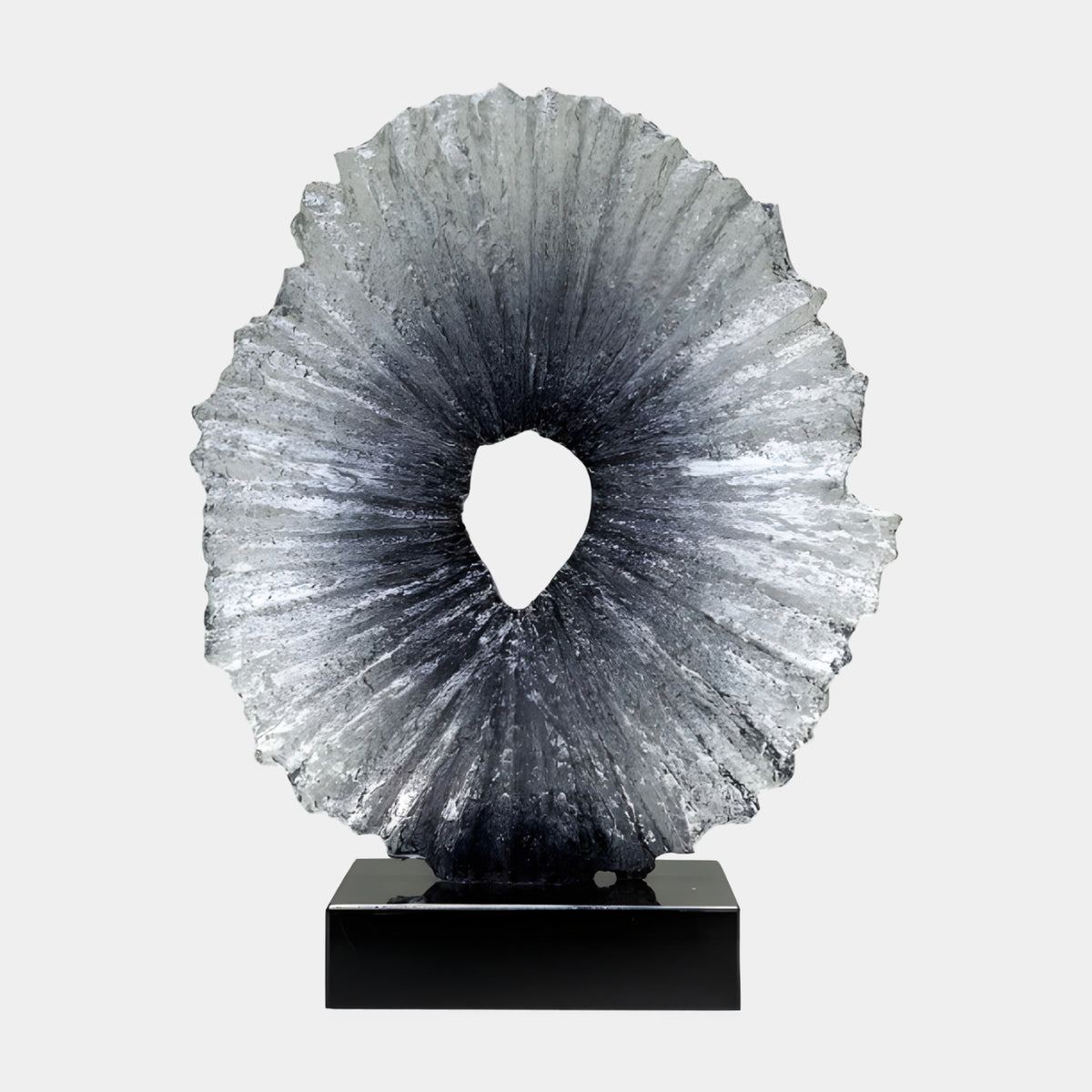 Black to Clear Radiating Disc Resin Sculpture, 66cm, with ribbed texture fading from black core to clear edges, set on a black marble base against a plain white background.