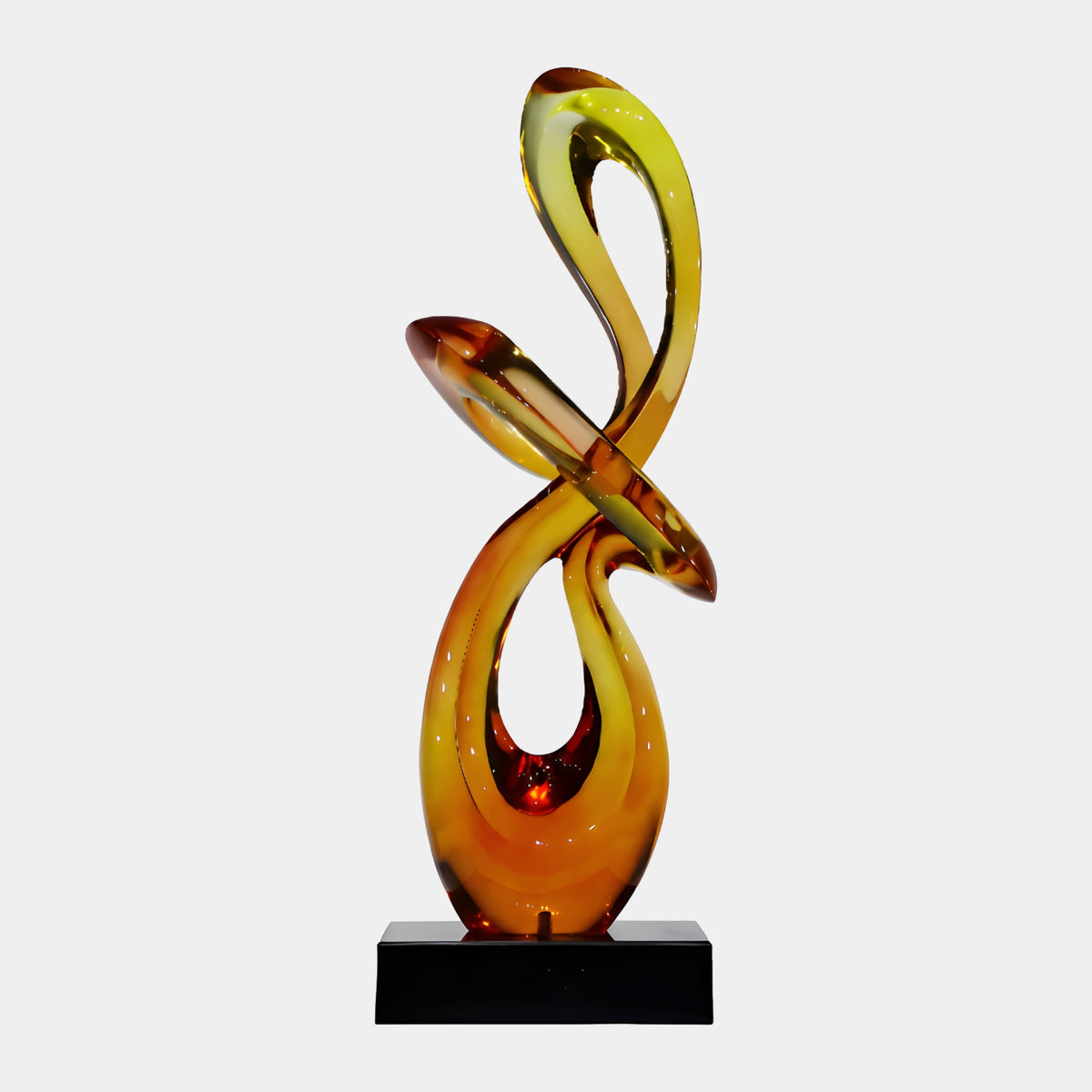 Amber Looped Ribbon Knot Resin Sculpture, 80cm, deep orange base loops lightening to honey-gold above, on a black marble block, plain white background.