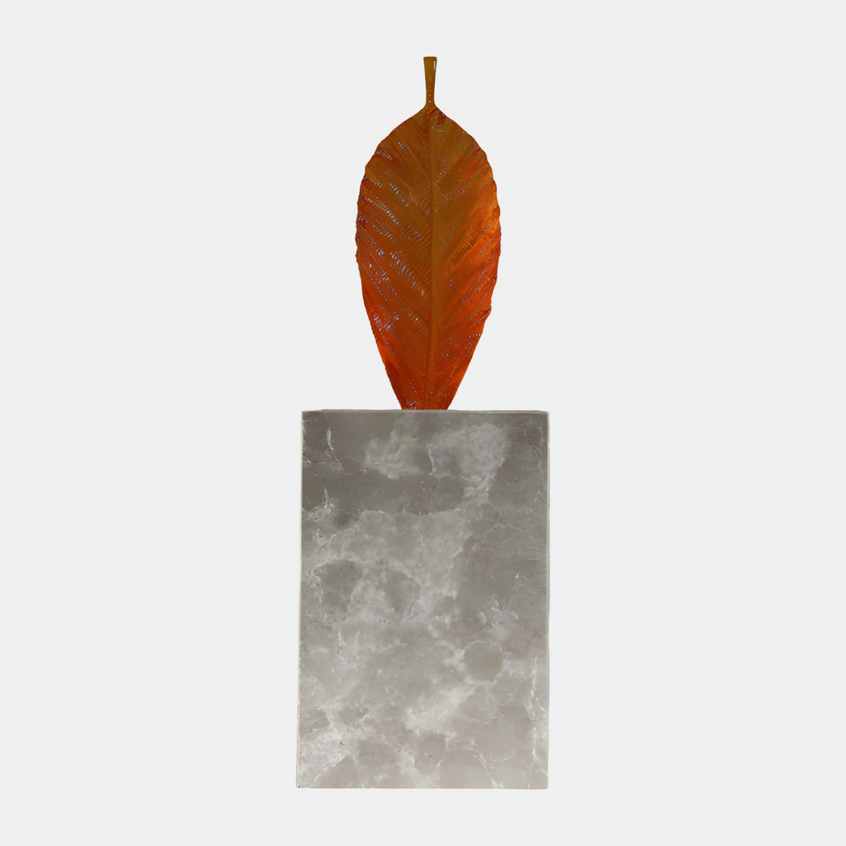 Orange Veined Leaf Resin Sculpture - 103cm, an amber-to-orange veined leaf rising from a tall pale marble block, shown on a plain white background.