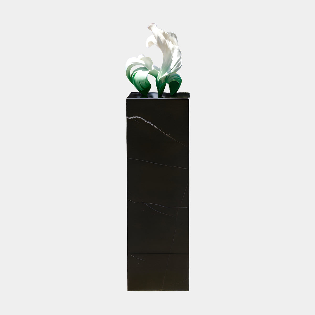 White & Green Curling Leaf Sculpture, resin blades fading from green to white, atop a 130cm black marble plinth with veining, plain background.