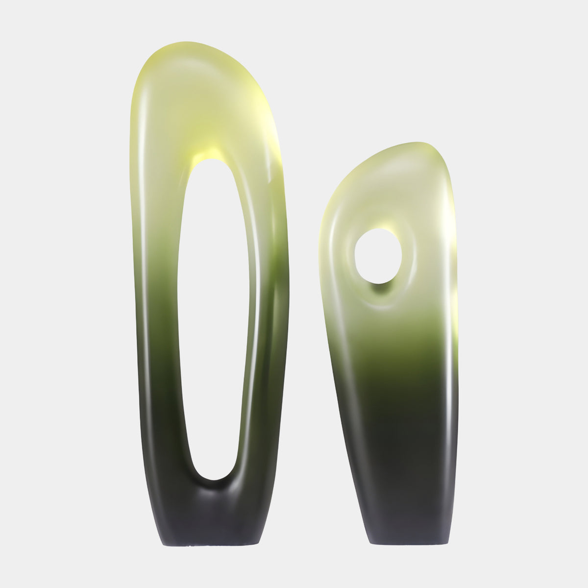 Giant Sculptures Green to Black Pierced Resin Sculpture, two matt abstract forms with tall oval and round cutouts, yellow-green to black finish, on a white background.