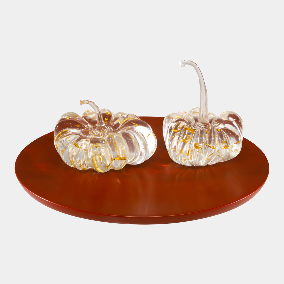 Clear & Gold Pumpkin Set Resin Sculpture - 50cm, two ribbed clear pumpkins with gold flecks and curling stems on a round red lacquered tray, white background.