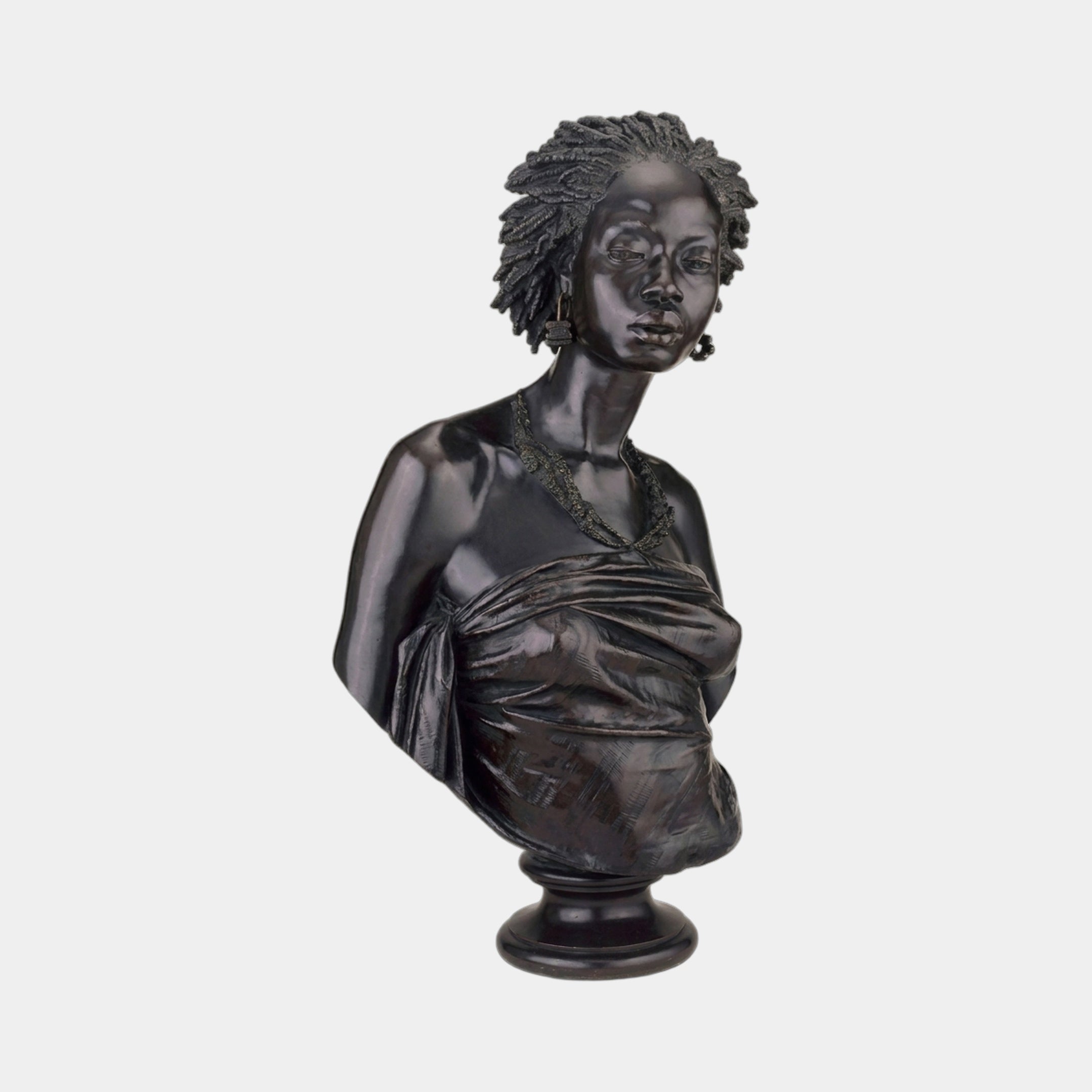 Classical African Woman Bronze Bust 70cm by Giant Sculptures, three-quarter view with braided hair, beaded earrings and draped cloth on a stepped pedestal.