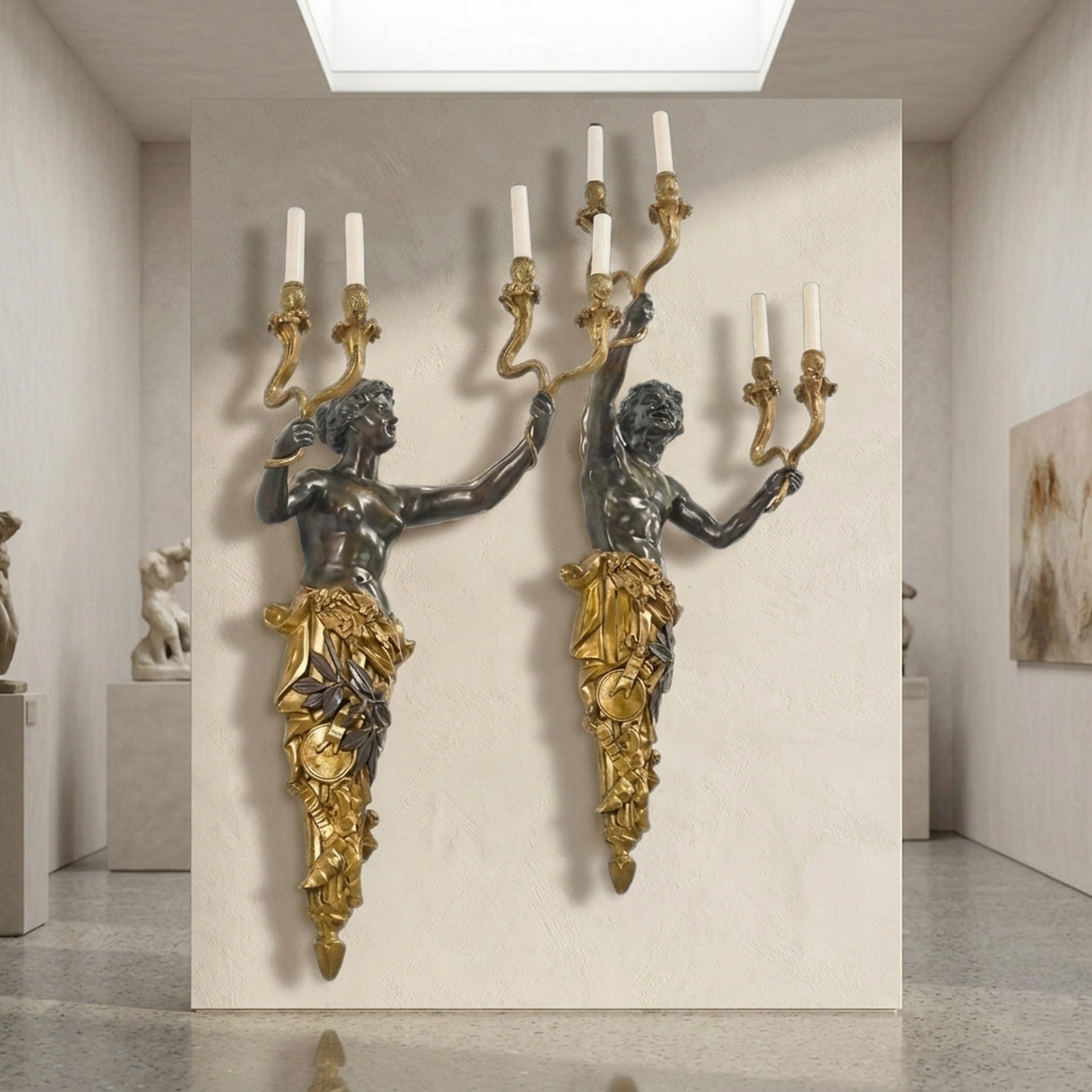 Pair of Giant Sculptures Classical Figural Torso Wall Sconces in dark patinated bronze with gilded drapery and three-arm candelabra, displayed in a gallery interior.