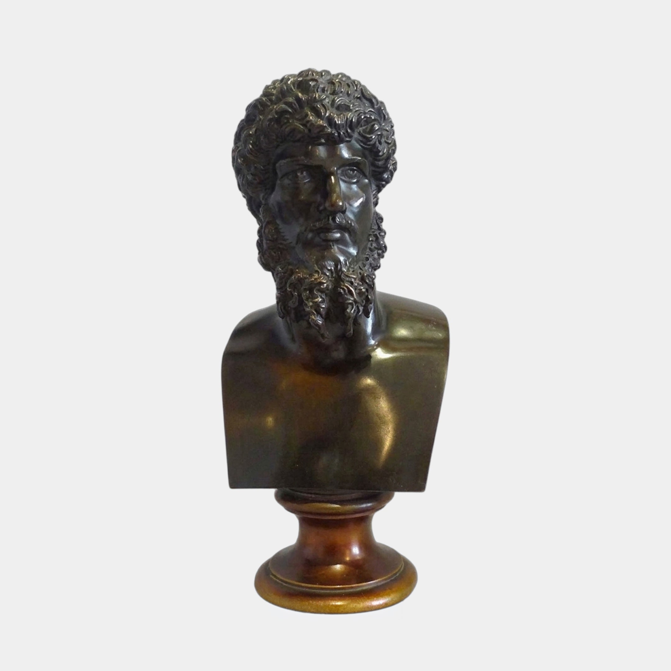 Classical Male Bust Bronze Sculpture from Giant Sculptures, a bearded Greco-Roman head with dark patina on a turned wooden pedestal against a plain background.