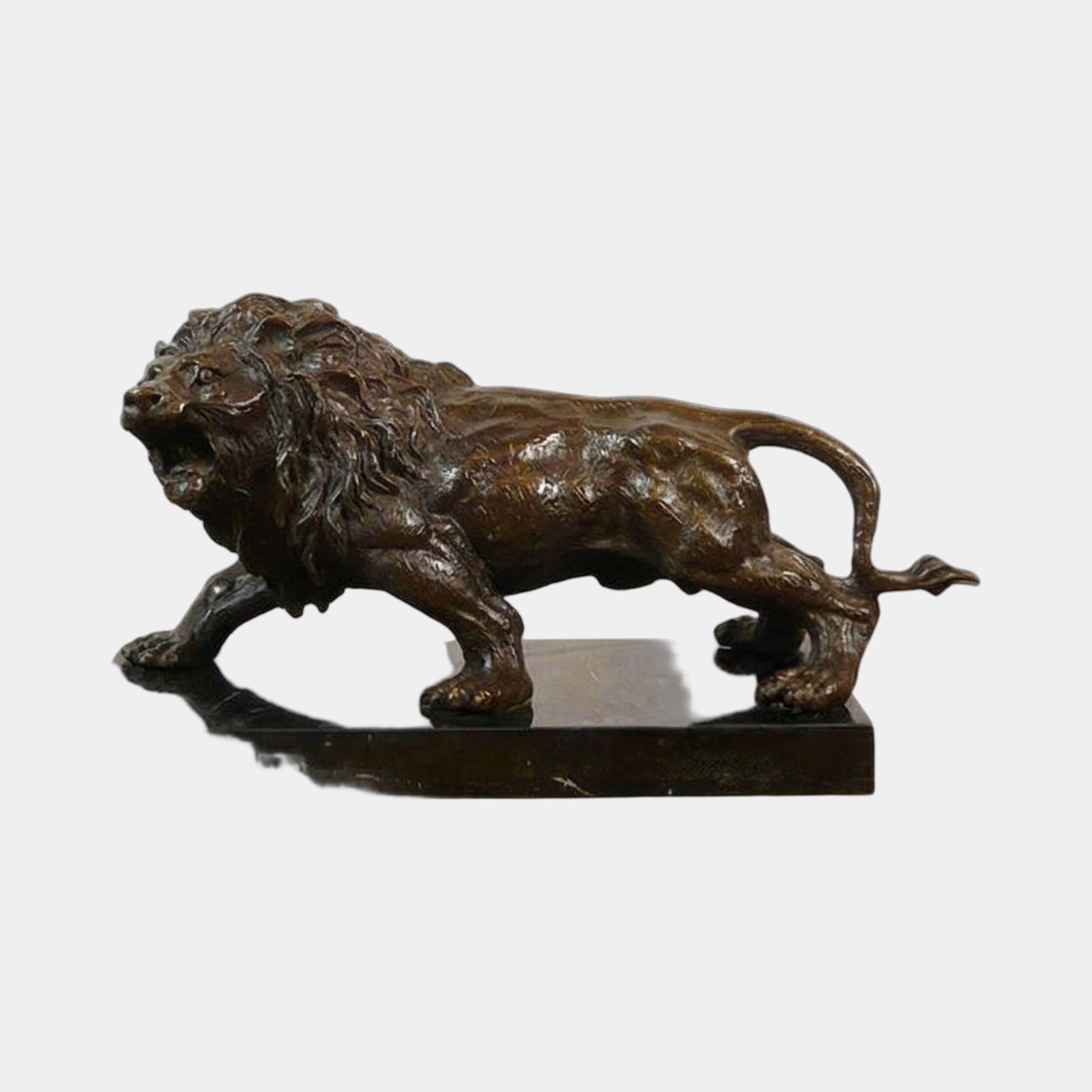 Classical Prowling Lion Bronze Sculpture by Giant Sculptures, shown in side view mid-stalk with open roar and raised tail, on a black marble plinth.