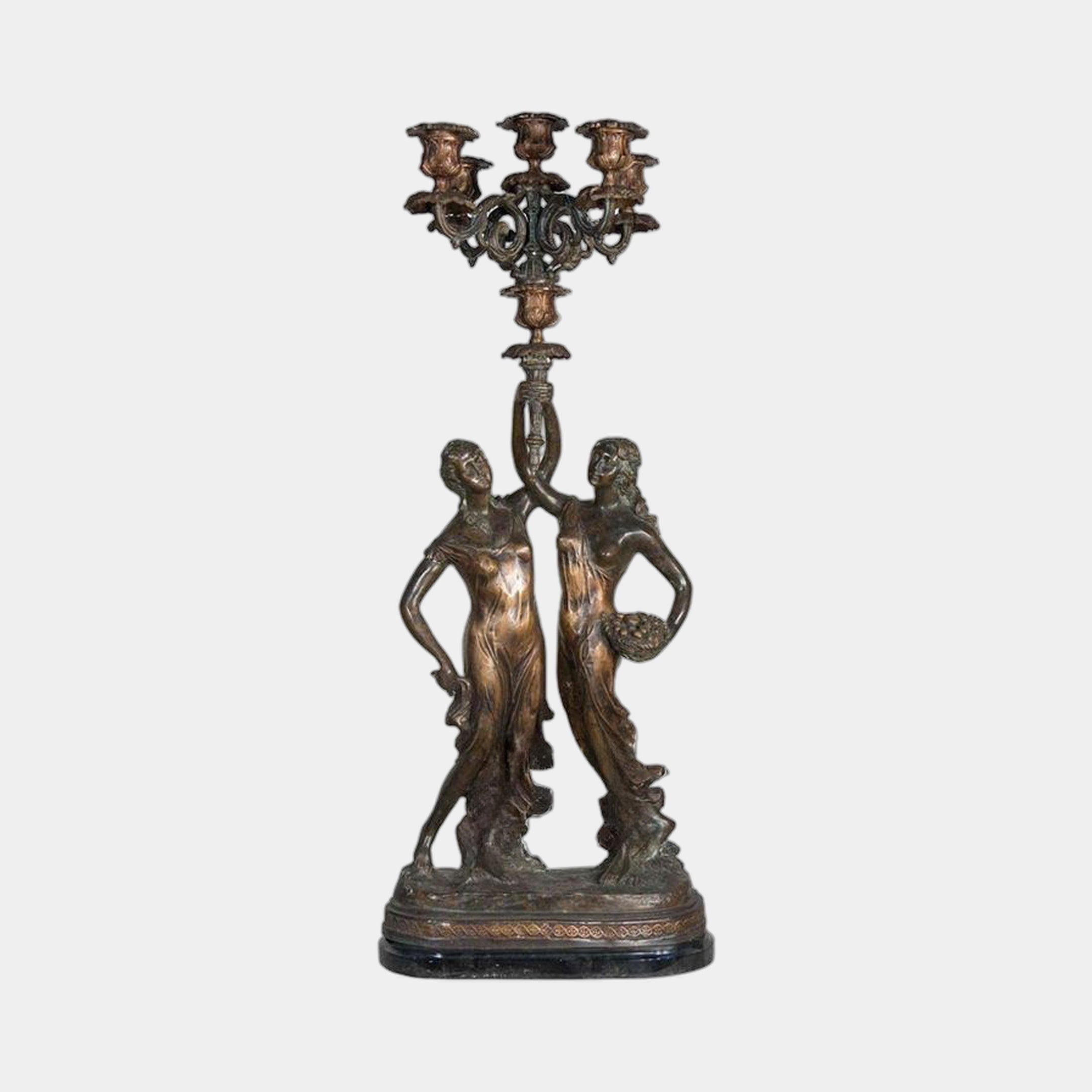 Classical Two Female Figures Candelabra Bronze Sculpture by Giant Sculptures, showing two draped women supporting a five-arm candelabra on a black marble plinth.