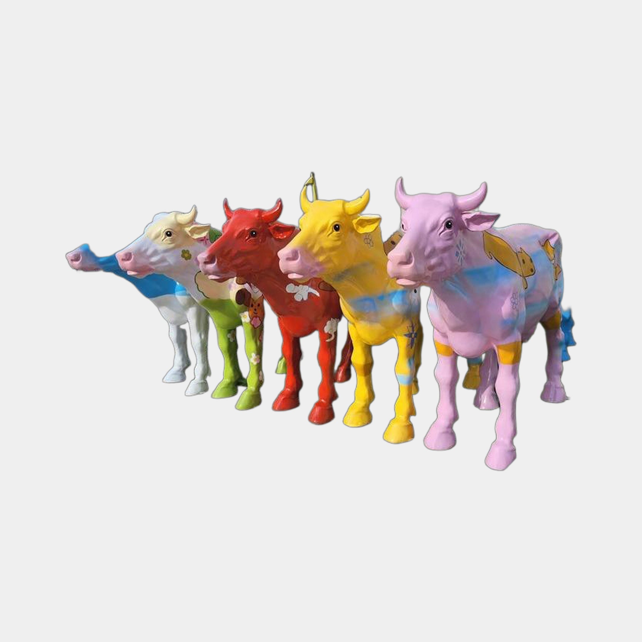 Giant Sculptures Contemporary Life-Size Painted Cow Bronze Sculptures grouped in white, green, red, yellow and pink high-gloss finishes on a plain background.