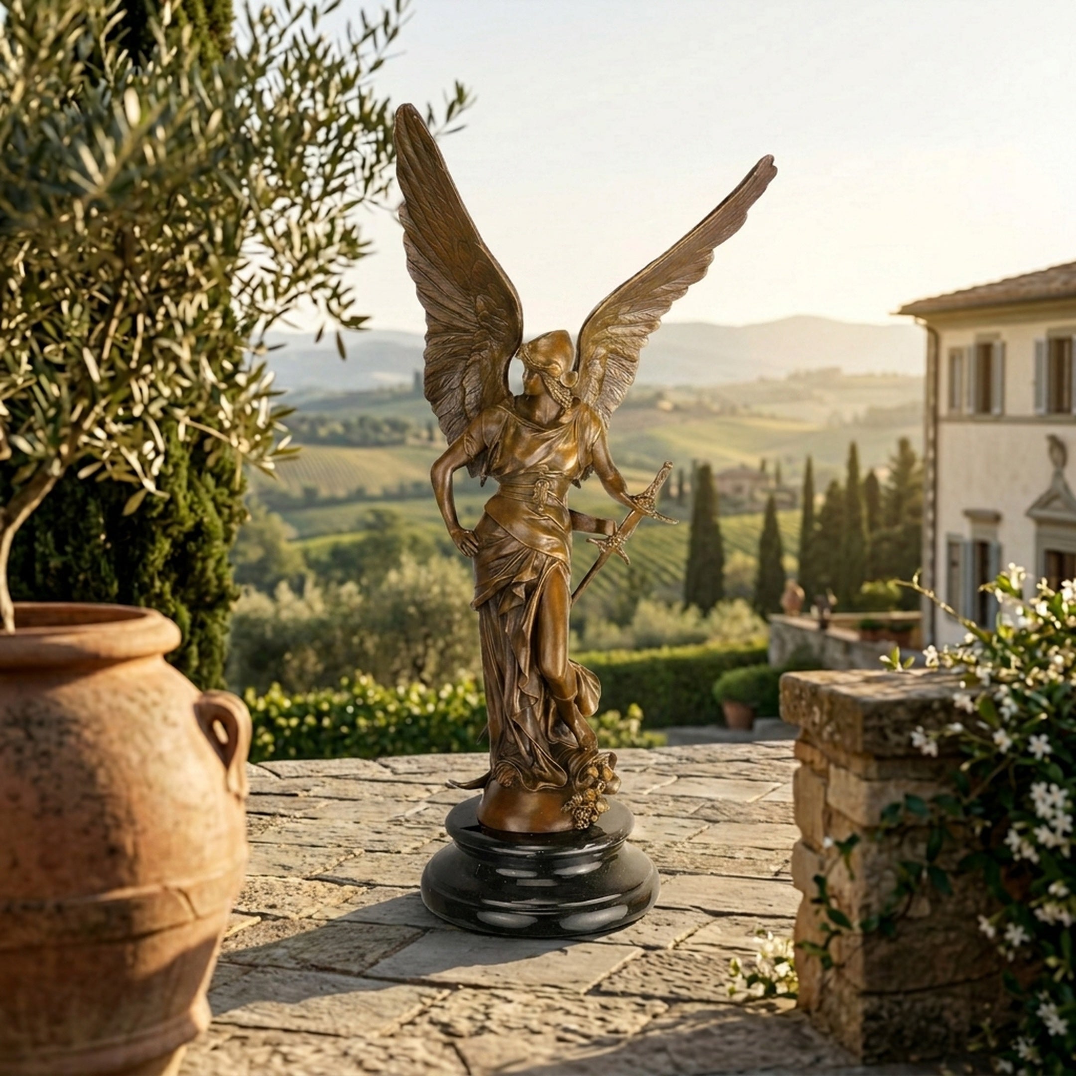Large Classical Archangel Michael Bronze Sculpture by Giant Sculptures with wings spread and sword, on a dark round plinth overlooking a Tuscan vineyard.