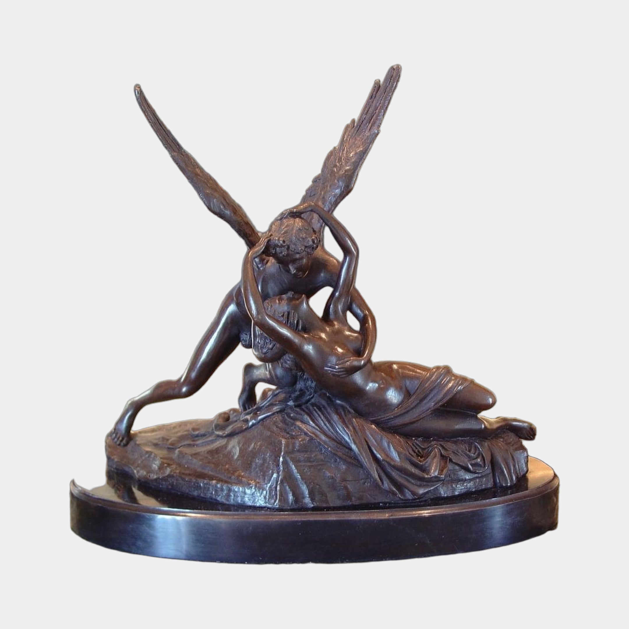 Large Classical Cupid and Psyche Bronze Sculpture by Giant Sculptures, winged Cupid embracing reclining Psyche, dark patina on oval marble base.