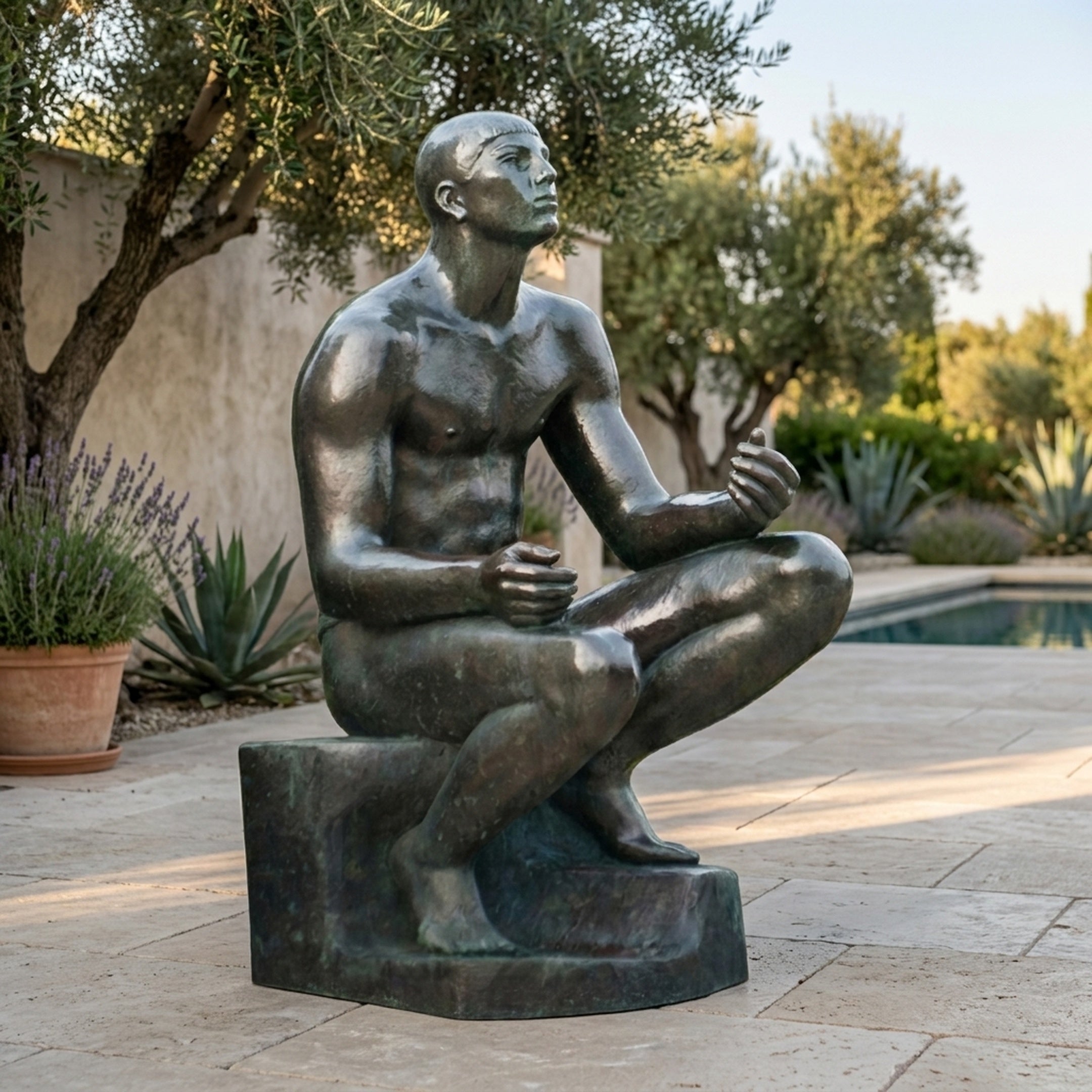 Giant Sculptures Large Classical Seated Male Figure Bronze Sculpture 170cm with dark patina, seated cross-legged on a poolside patio near olive trees and lavender.