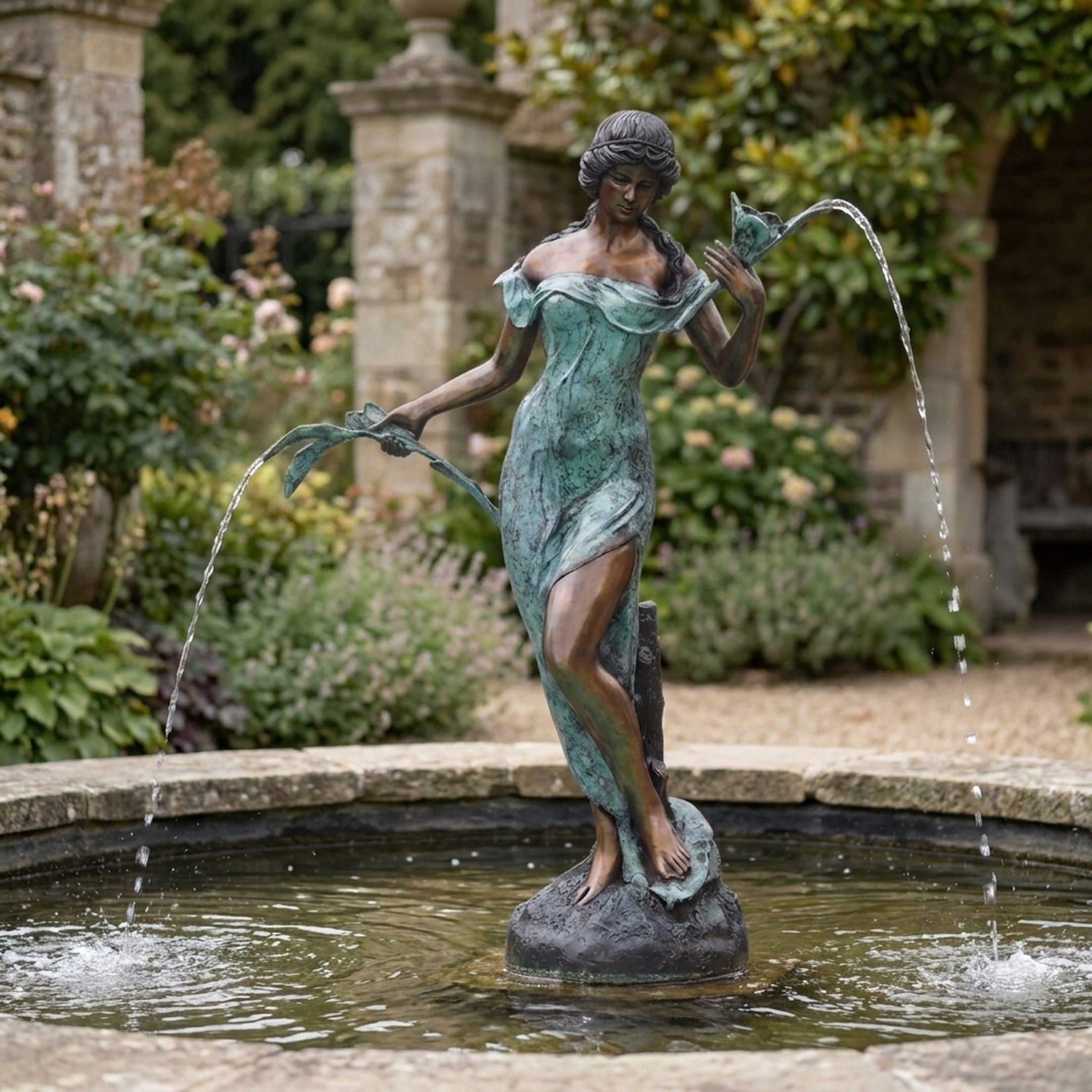 Large Classical Standing Goddess Bronze Fountain by Giant Sculptures, 170cm verdigris figure holding lily pad spouts above a garden pool with stone arches.