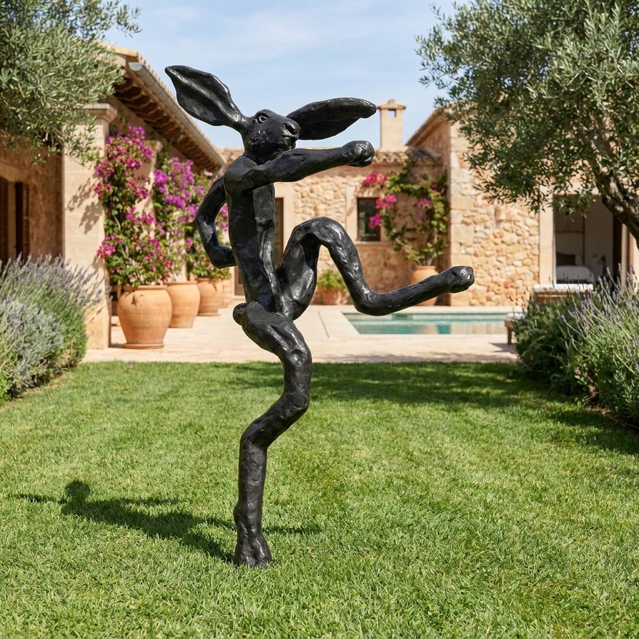 Large Contemporary Dancing Hare Bronze Sculpture by Giant Sculptures, 150cm black matte figure mid-leap on a lawn beside a stone villa and pool.