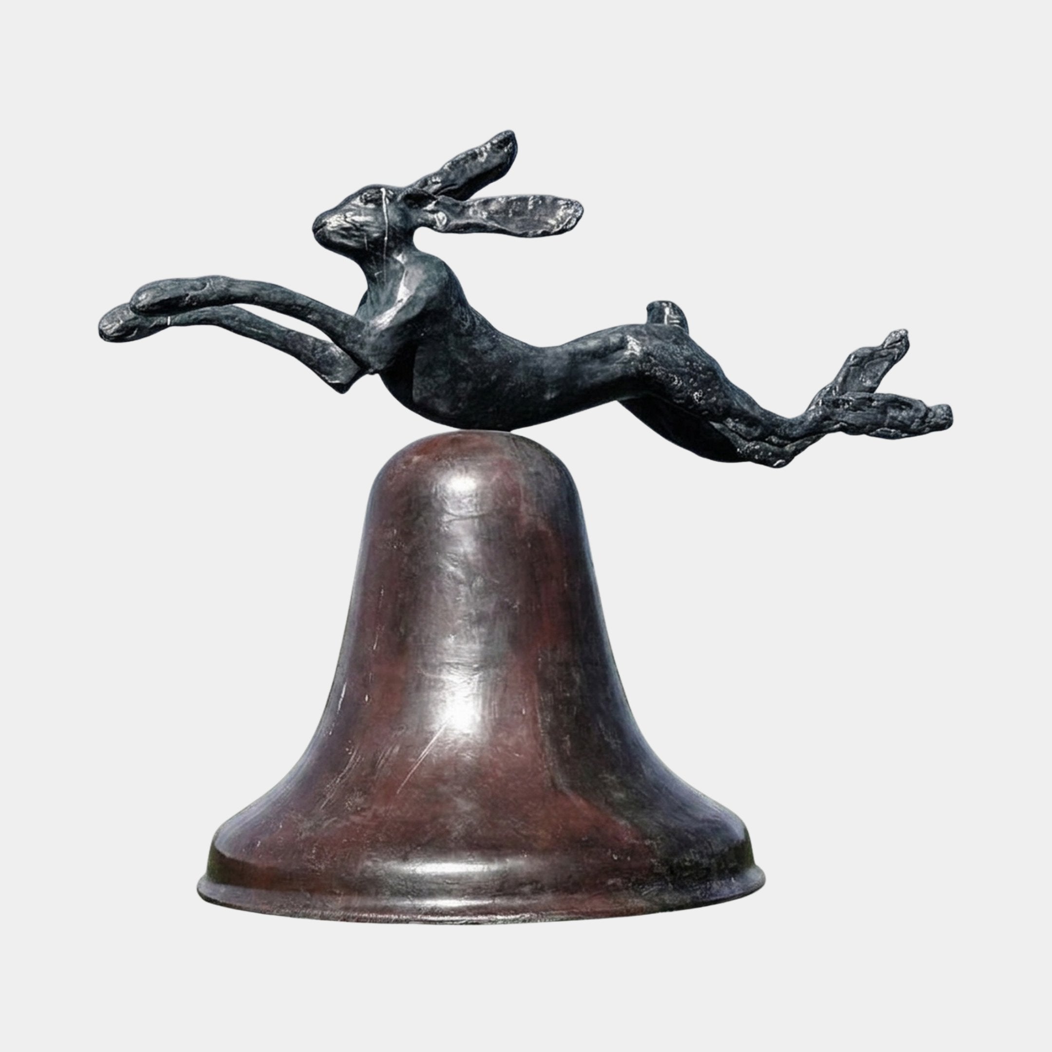 Large Contemporary Leaping Hare and Bell Bronze Sculpture by Giant Sculptures, dark patinated hare mid-leap above a reddish-brown bell form on a plain background.