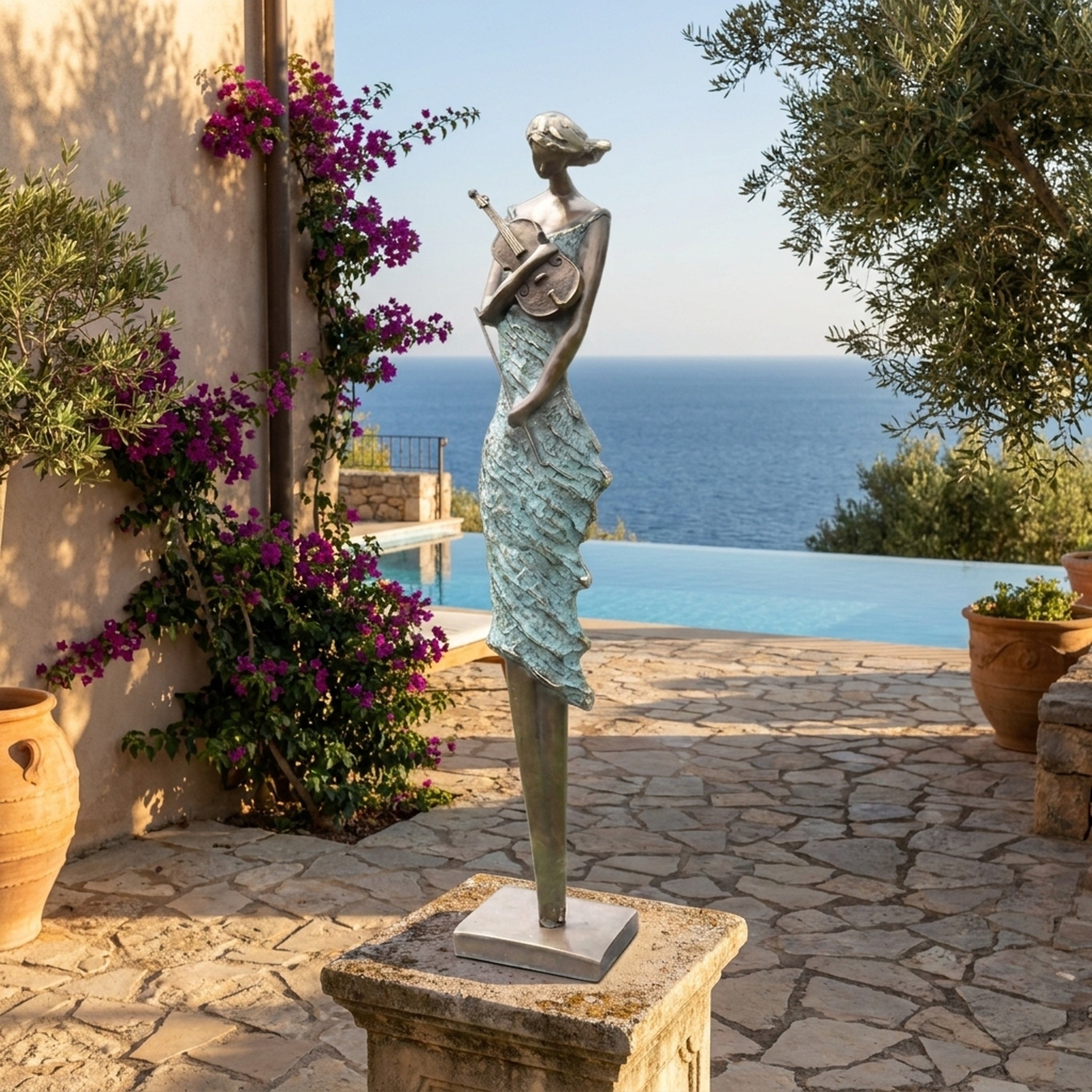 Large Contemporary Violinist Bronze Sculpture by Giant Sculptures on a stone plinth beside an infinity pool with sea views, bougainvillea, and olive trees.