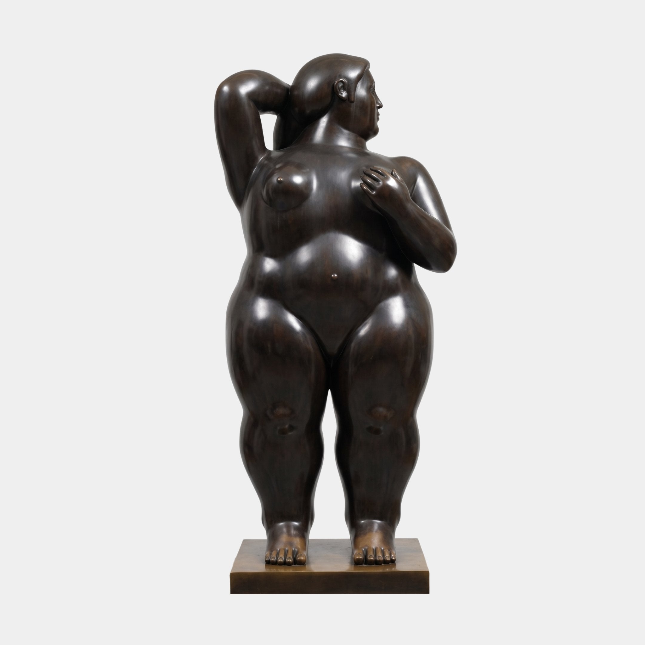 Large Contemporary Voluptuous Female Figure Bronze Sculpture by Giant Sculptures, 250cm nude with one arm raised, dark patina, on pale gold plinth.