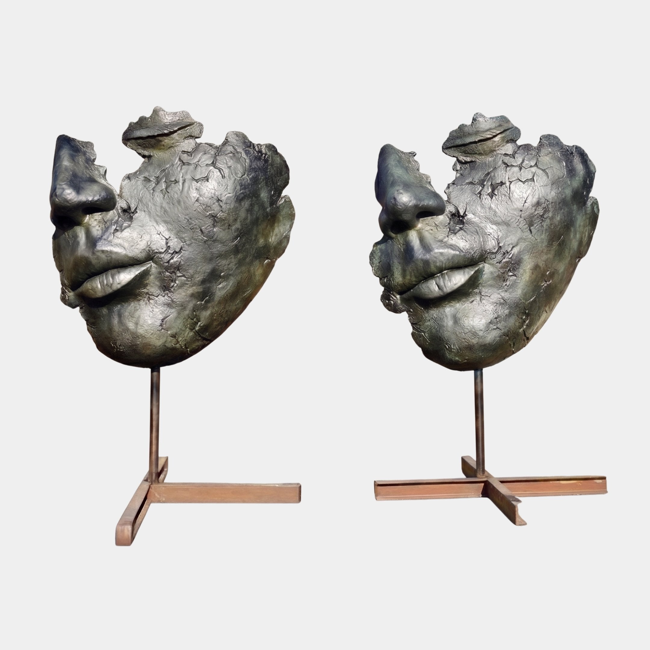 Giant Sculptures' Large Modern Abstract Face Fragment Bronze Sculpture 180cm, two cropped faces with frogs atop, facing each other on steel pole bases.