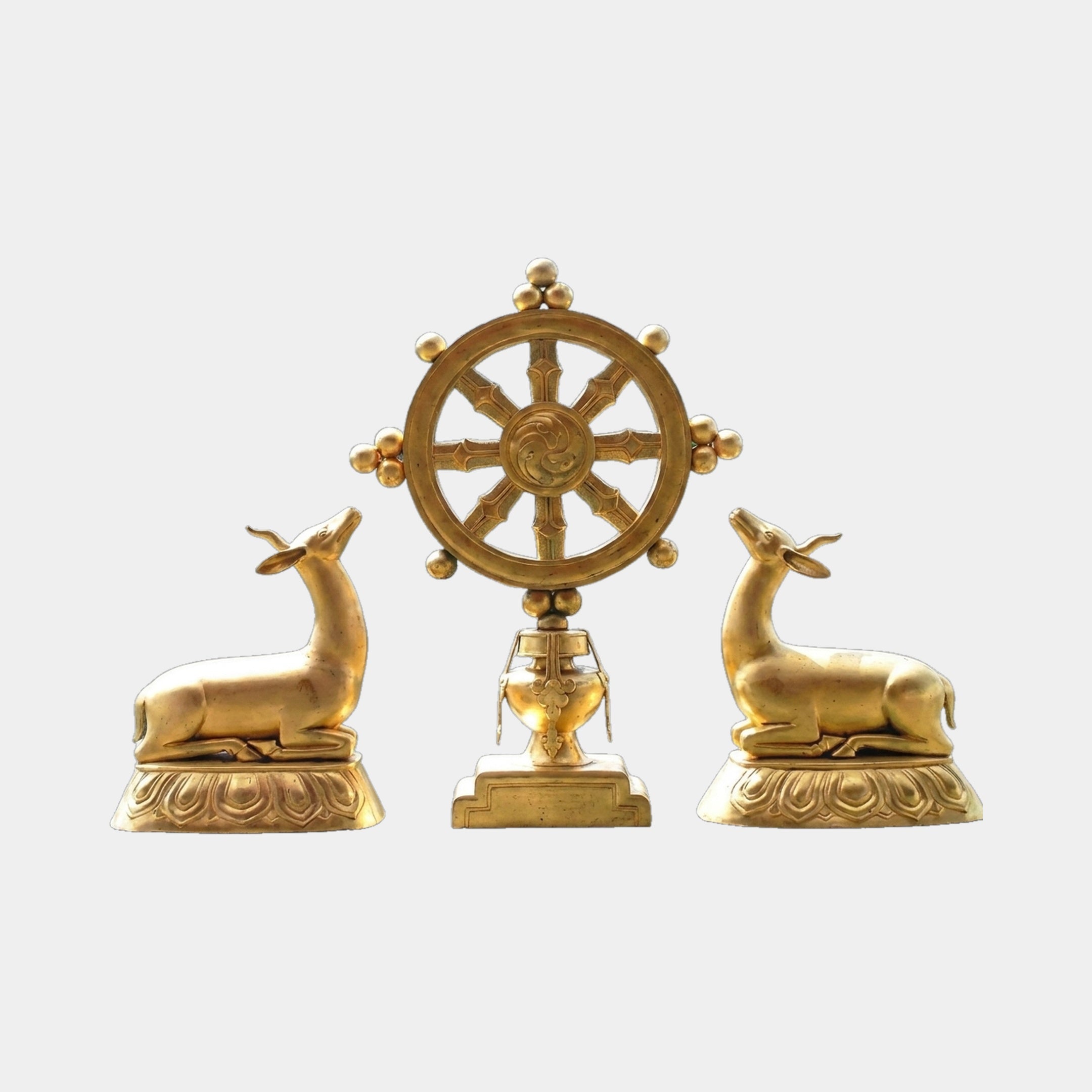 Large Traditional Recumbent Deer and Dharma Wheel Bronze Sculpture by Giant Sculptures in polished gold, two deer flanking a central wheel on a plain background.