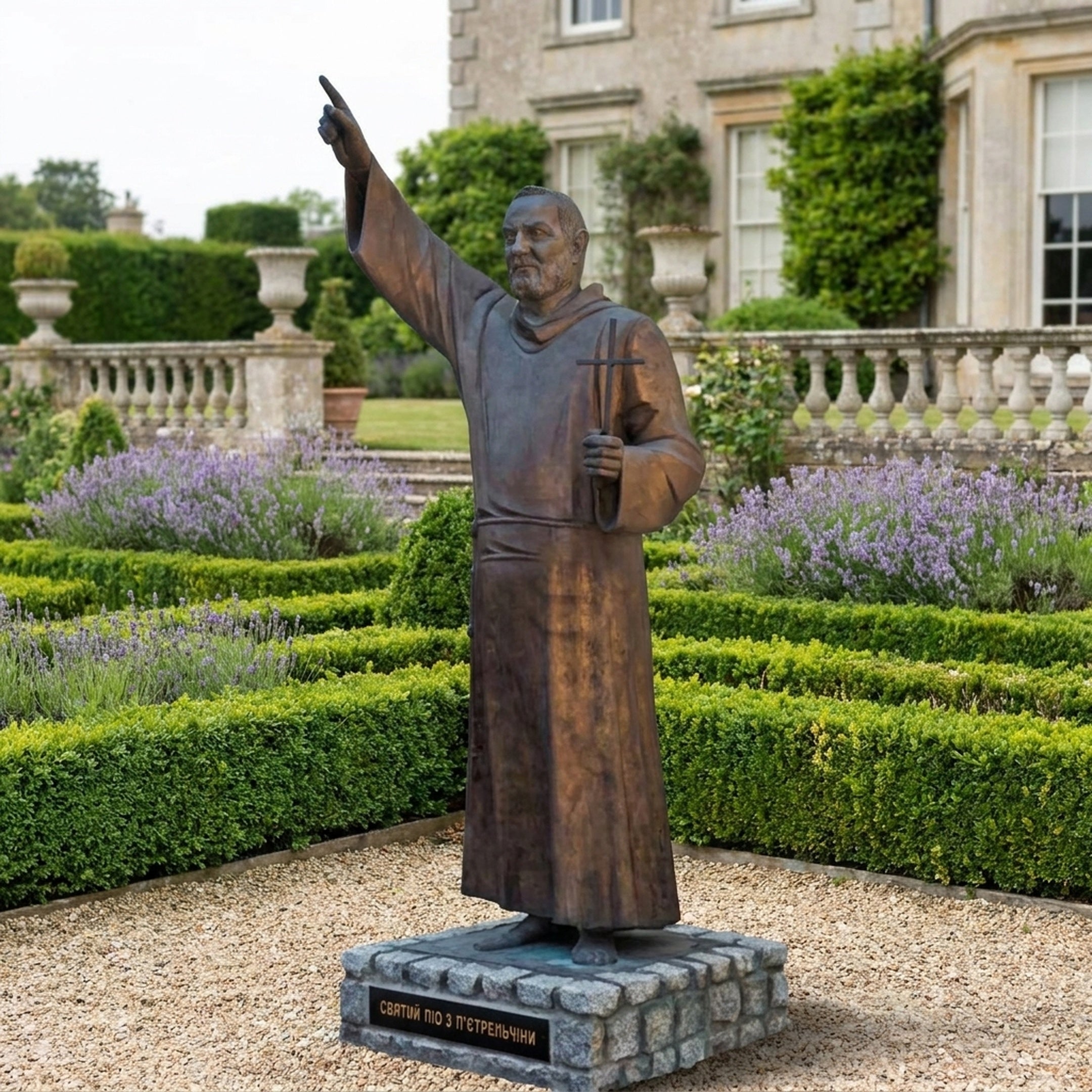 Giant Sculptures' 210cm Large Traditional Robed Figure Bronze Sculpture on a stone plinth, right arm raised skyward and left hand holding a cross, in a formal garden.