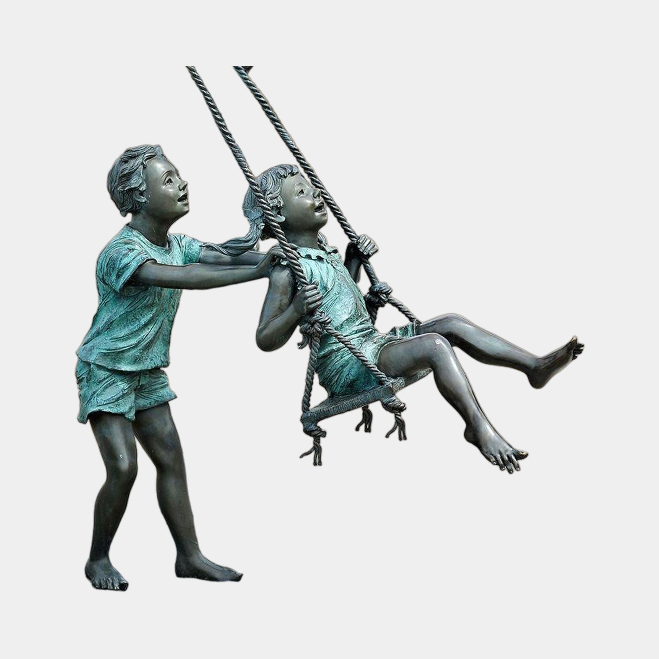 Life-Size Children on Swing Bronze Sculpture by Giant Sculptures showing a boy pushing a seated girl on a rope swing, verdigris patina, plain background.