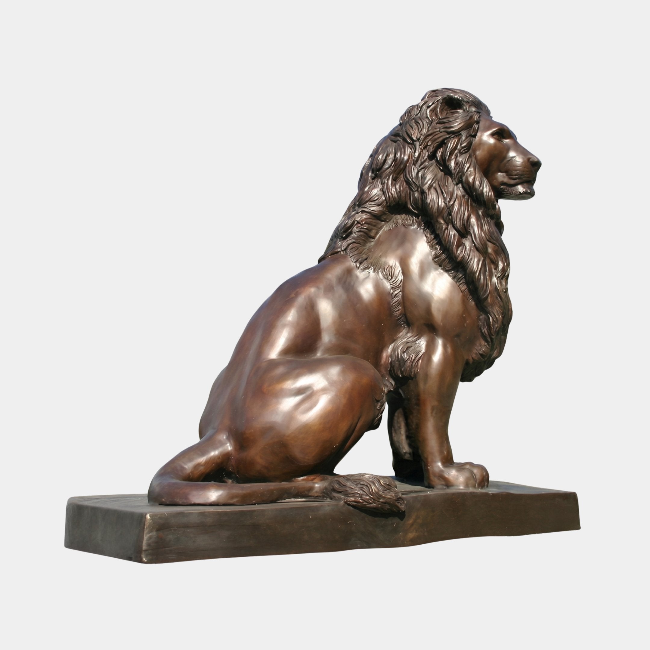 Life-Size Classical Seated Lion Bronze Sculpture by Giant Sculptures, side profile with flowing mane and warm brown patina, on a rectangular bronze base.