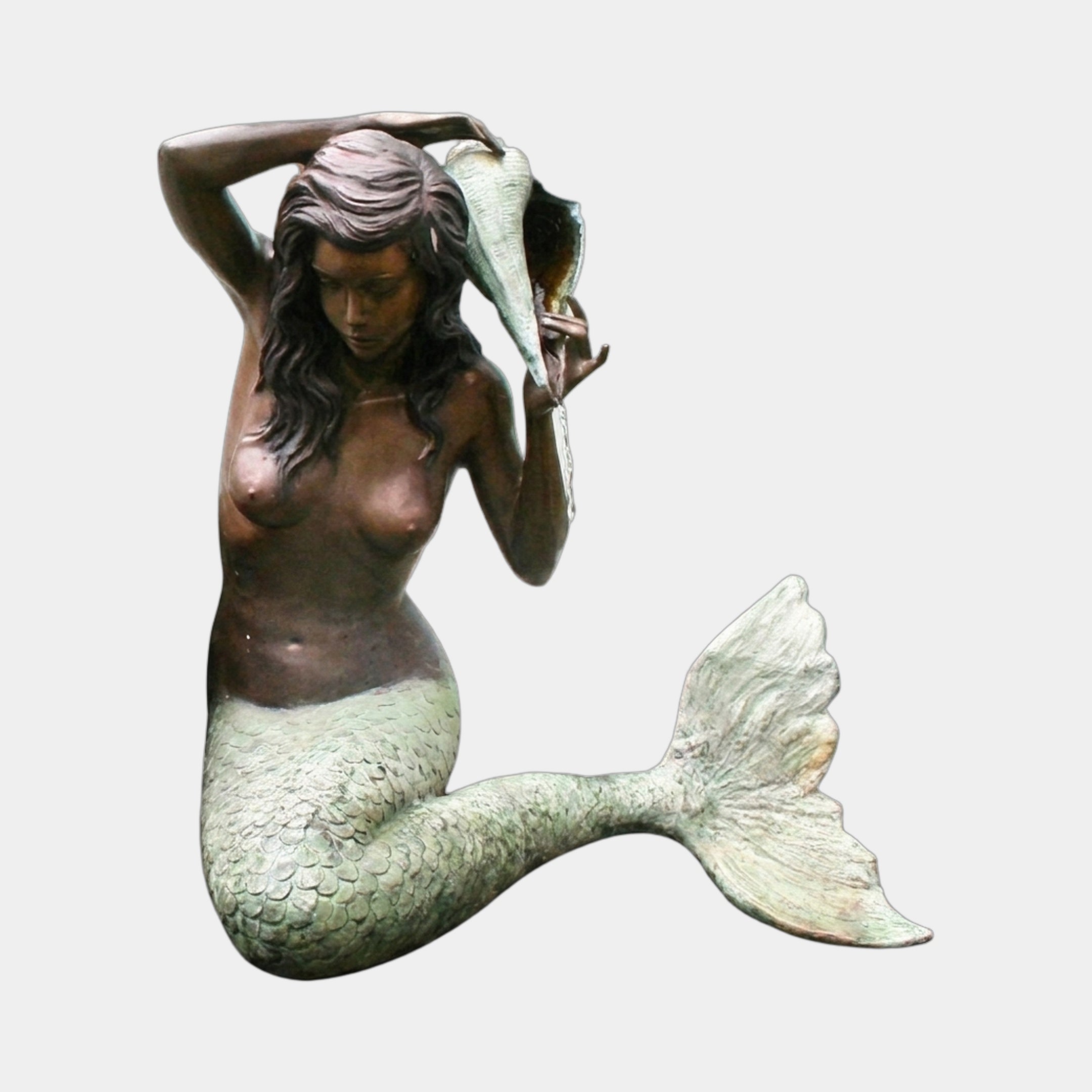 Giant Sculptures Life-Size Classical Seated Mermaid Bronze Fountain with brown patina torso, green verdigris tail, holding a conch shell aloft, on plain background.