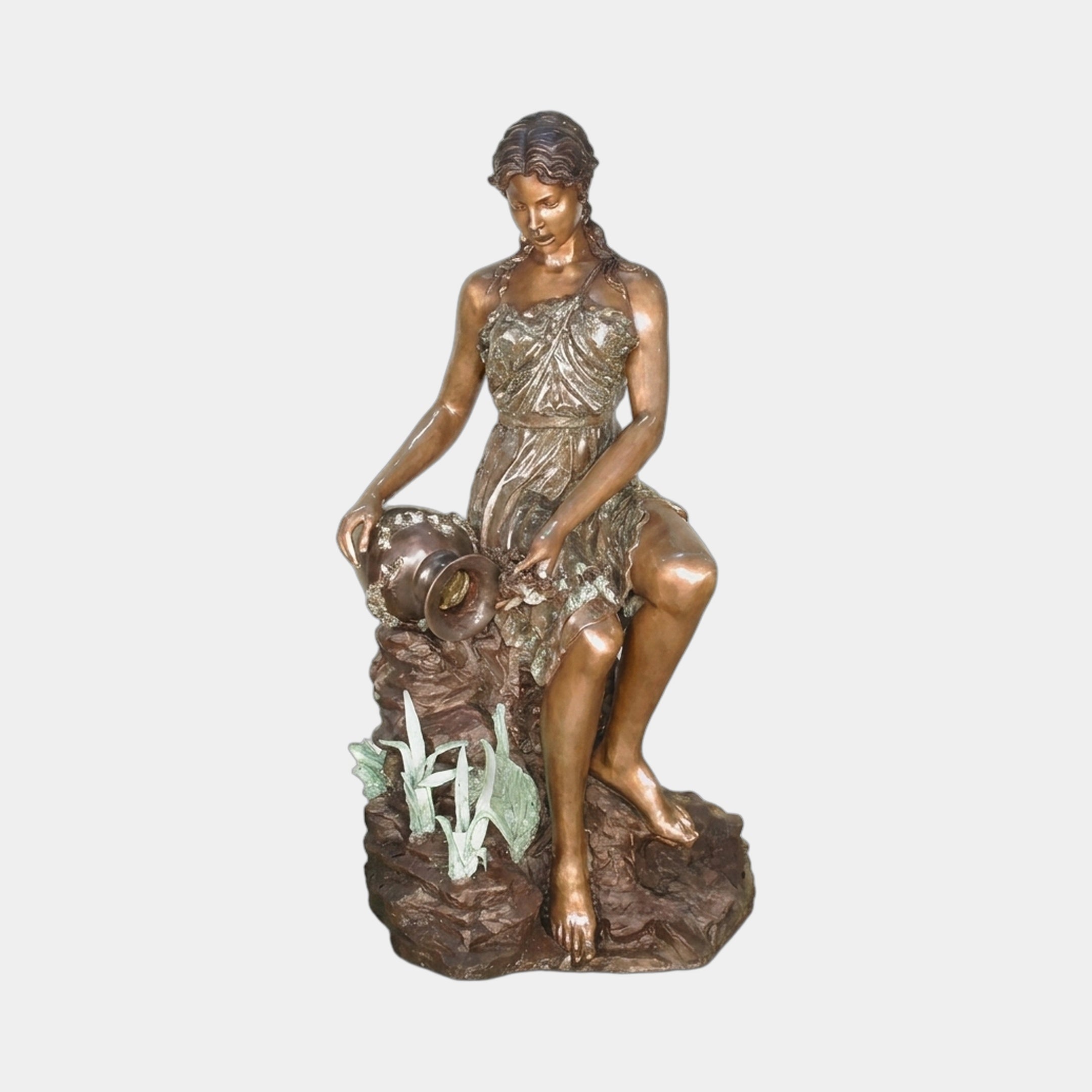 Life-Size Classical Seated Woman Pouring Water Bronze Fountain by Giant Sculptures, 160cm, shown tilting a vessel on a rocky base with verdigris foliage accents.