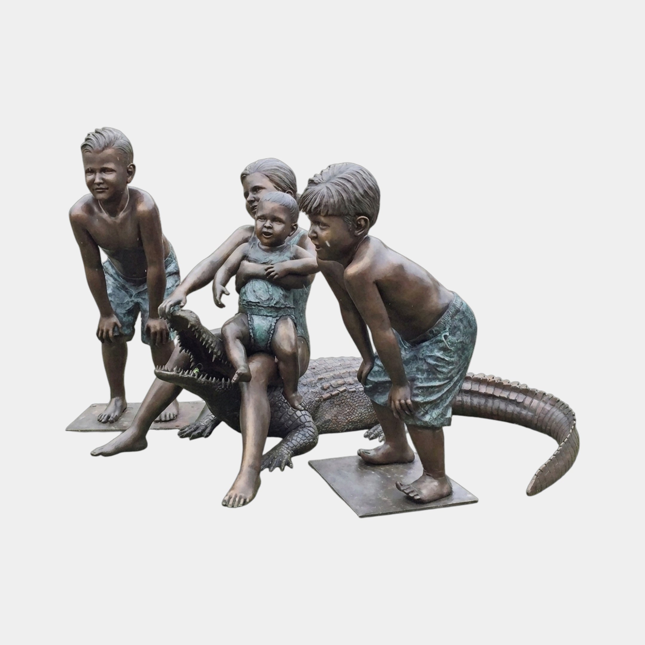 Life-Size Contemporary Children and Crocodile Bronze Sculpture by Giant Sculptures, showing four children in swimwear gathered around a crocodile with warm brown and verdigris patina.