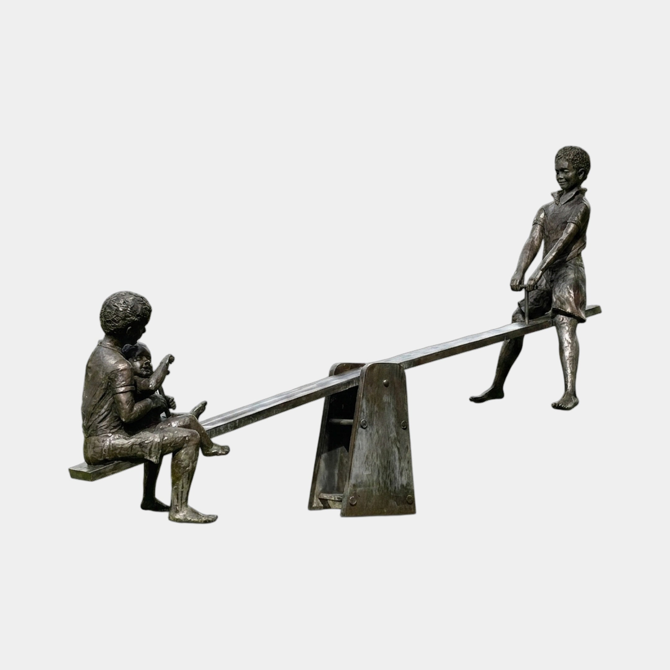 Life-Size Contemporary Children on Seesaw Bronze Sculpture by Giant Sculptures, dark patina finish showing three children at play, shown on a plain background.