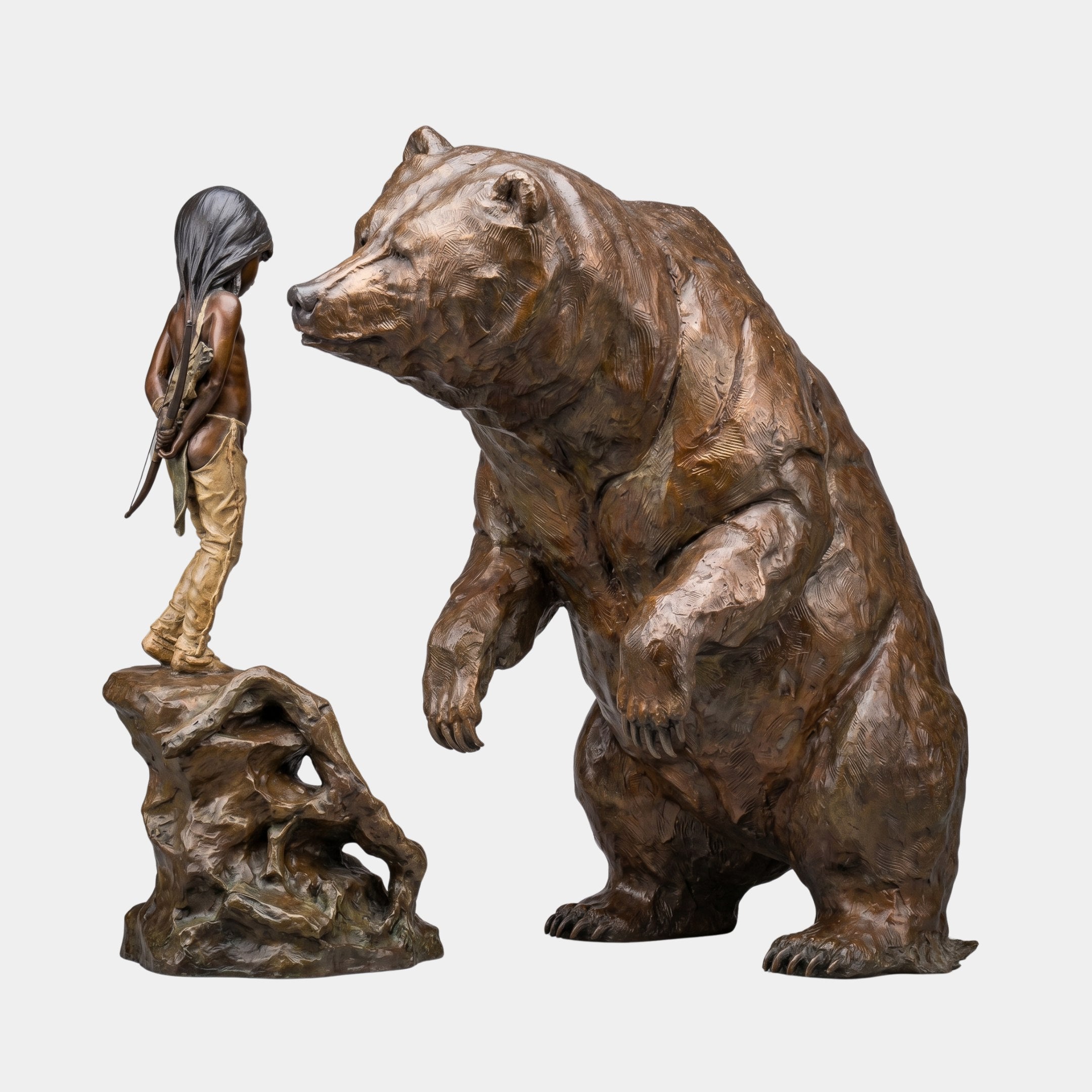Life-Size Contemporary Rearing Bear and Girl Bronze Sculpture by Giant Sculptures, showing a hooded girl on a rock facing a rearing bear, warm brown patina.