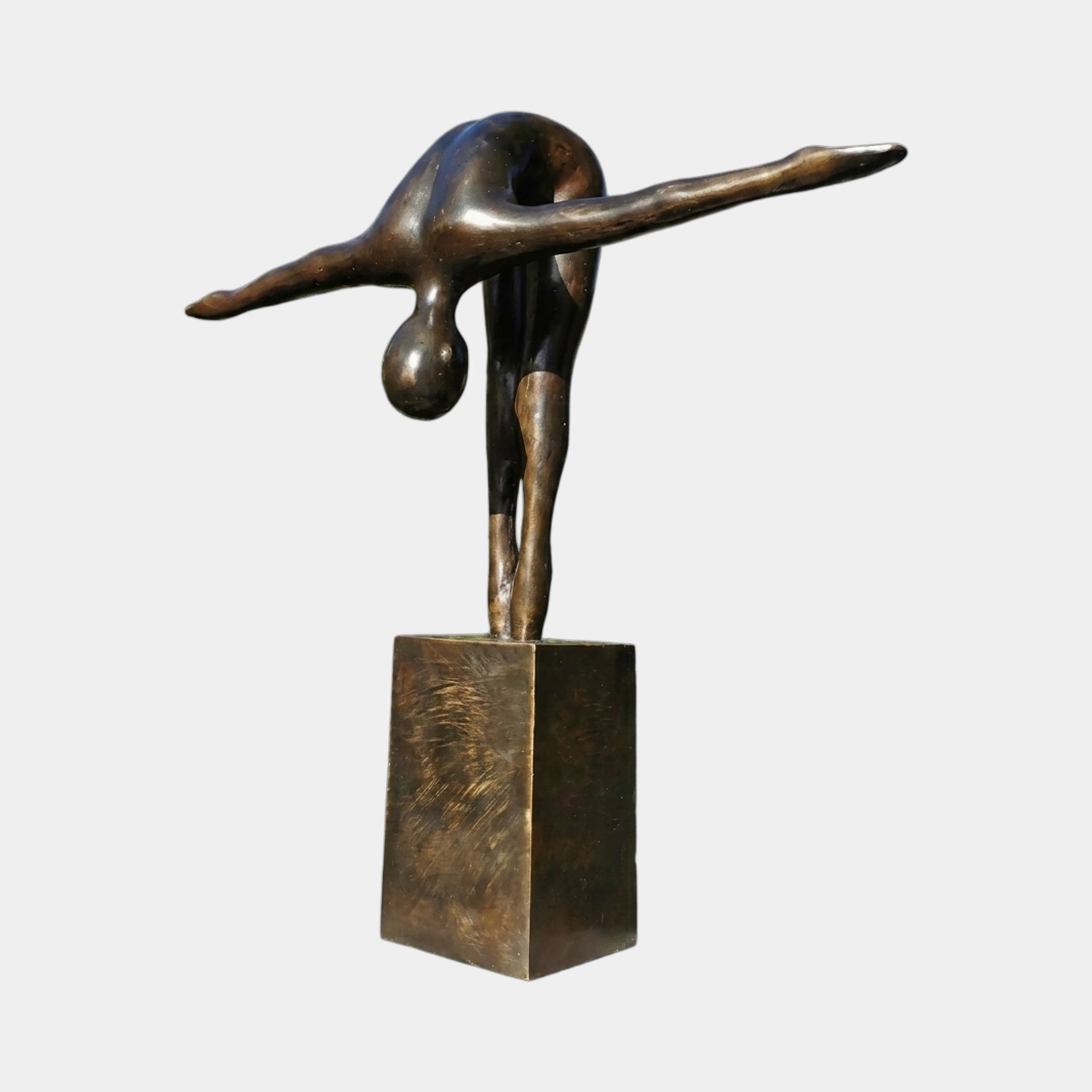 Life-Size Modern Abstract Diving Figure Bronze Sculpture by Giant Sculptures, shown folded forward with arms outstretched on a matching plinth against a plain background.