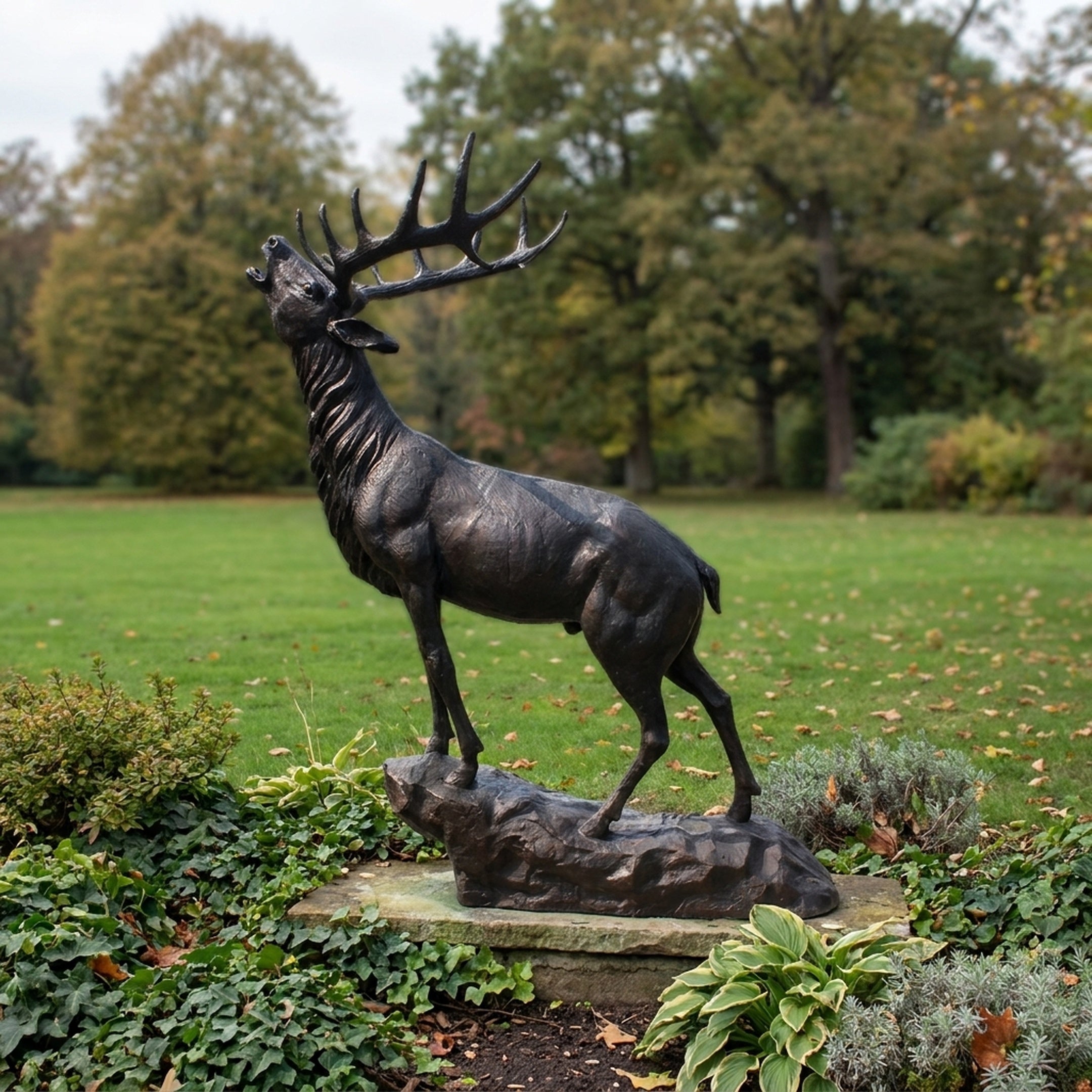 Life-Size Traditional Bugling Bull Elk Bronze Sculpture by Giant Sculptures, head raised mid-call on a rocky base, set in a garden with autumn trees behind.