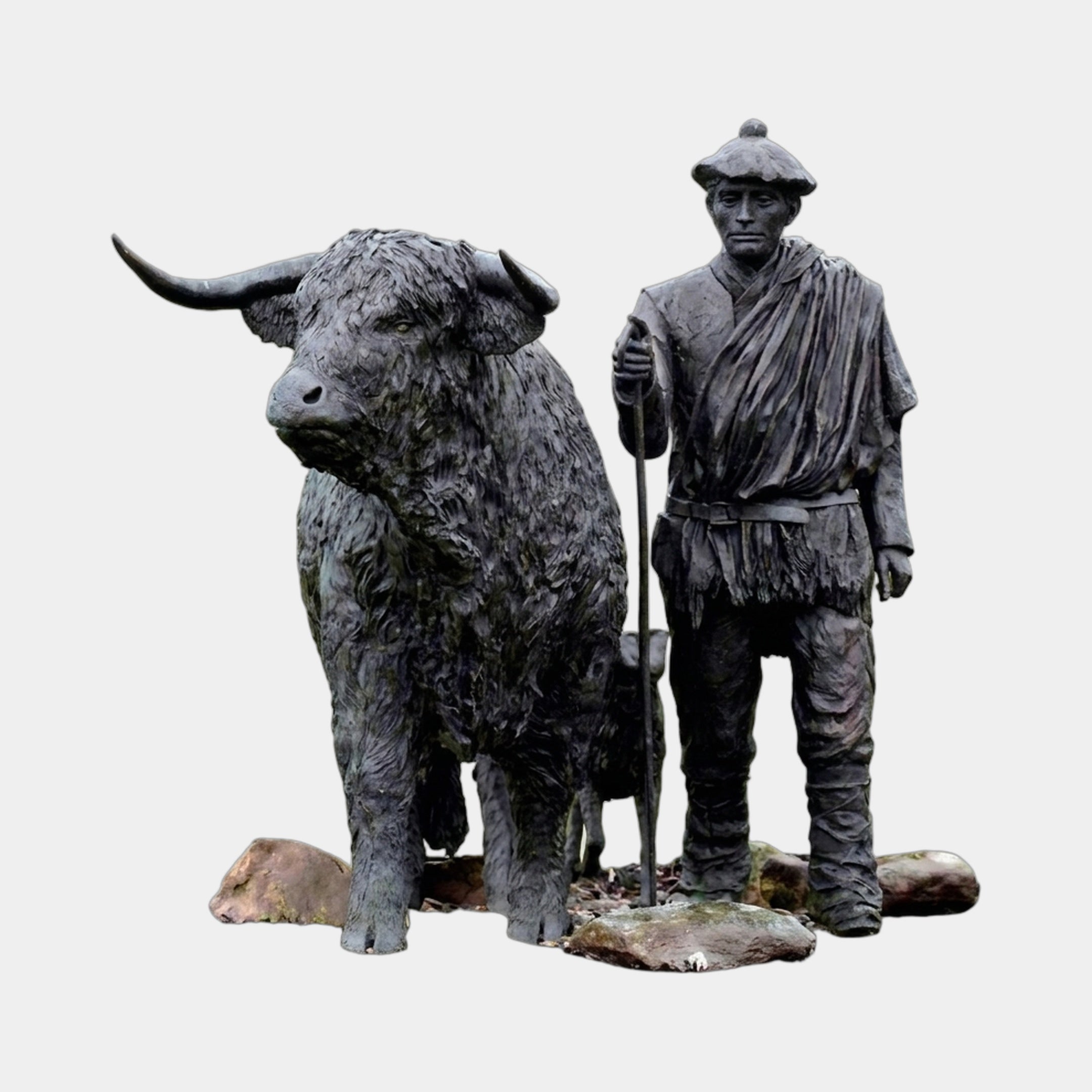 Giant Sculptures' 240cm Life-Size Traditional Highland Bull and Drover bronze group, shaggy horned bull beside a staff-bearing figure in layered garb on a rocky base.