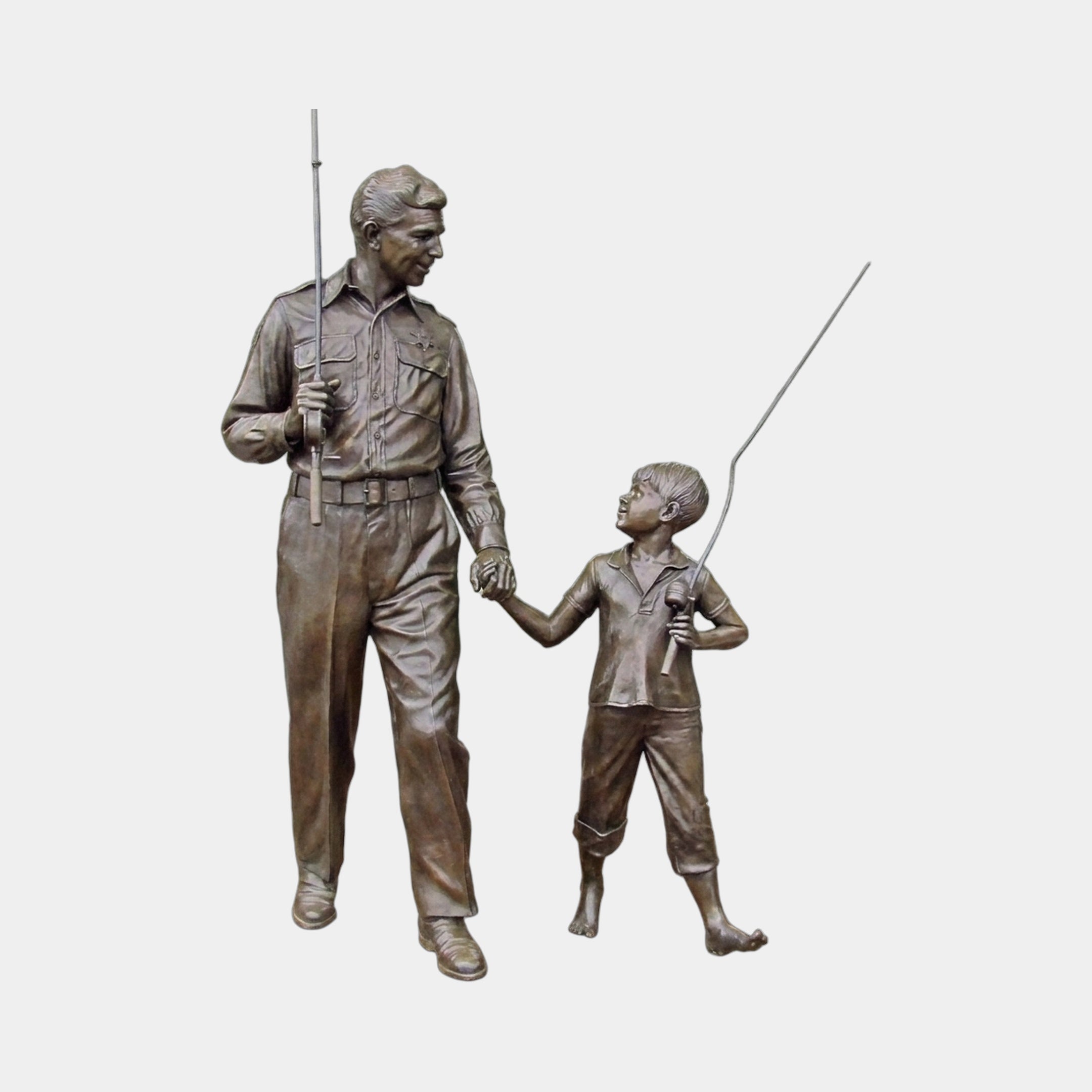 Life-Size Traditional Man and Boy Fishing Bronze Sculpture by Giant Sculptures, 230cm tall, showing the pair holding hands with fishing rods on a plain background.