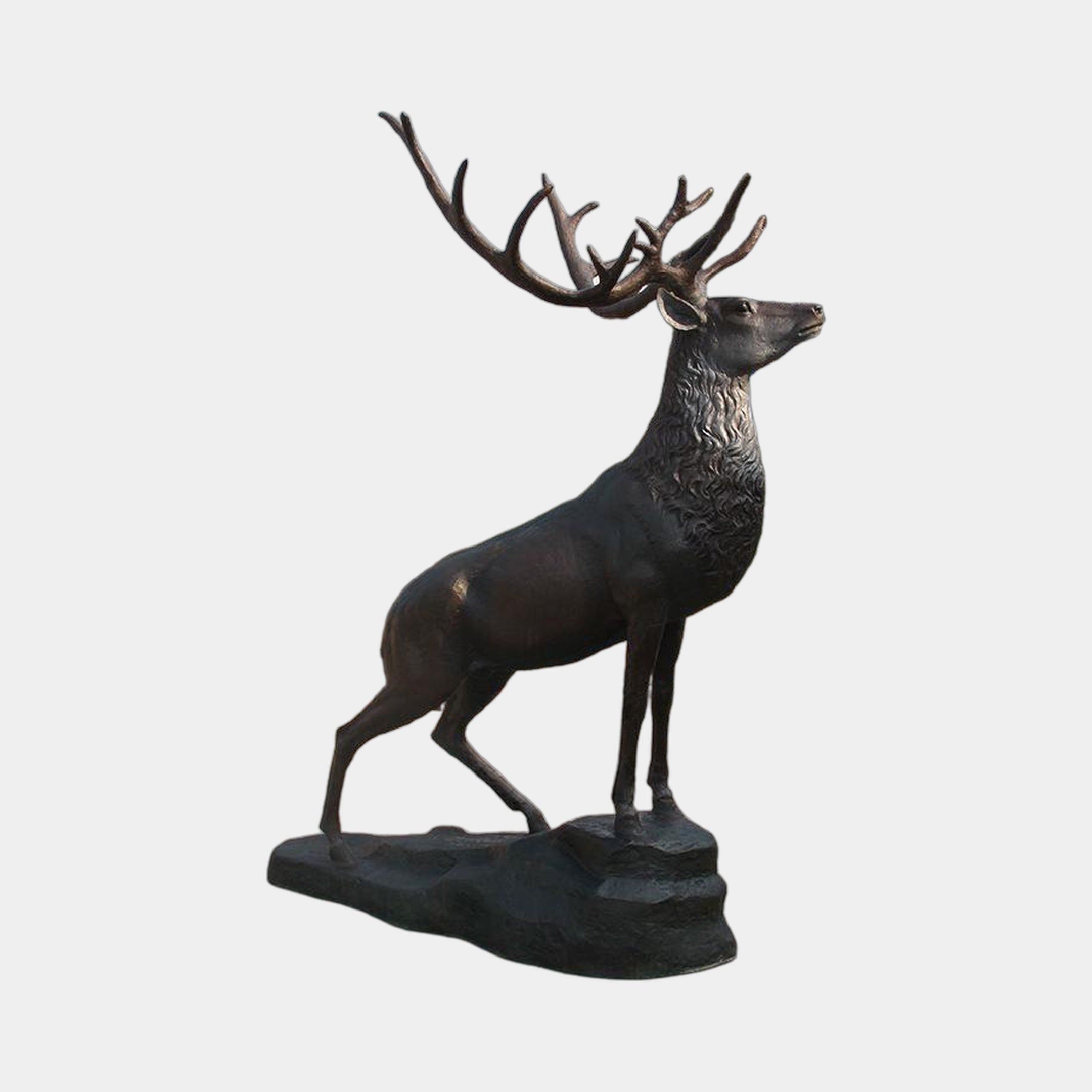 Life-Size Traditional Stag Bronze Sculpture by Giant Sculptures, shown in side view with head raised, wide multi-point antlers, and dark patina on a rocky integral base.