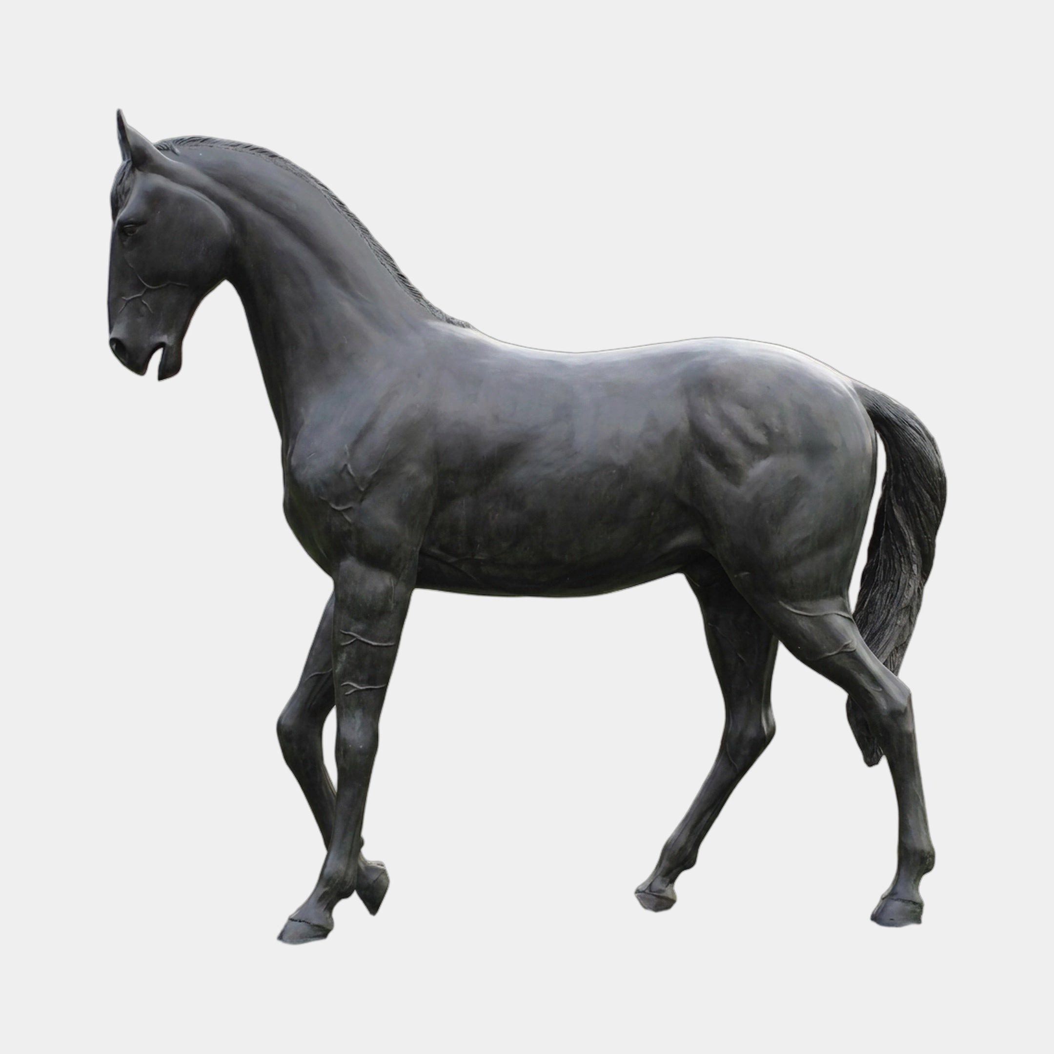 Life-Size Walking Horse Bronze Sculpture by Giant Sculptures shown in left-side profile with foreleg raised, dark charcoal-black patina, against a plain light background.