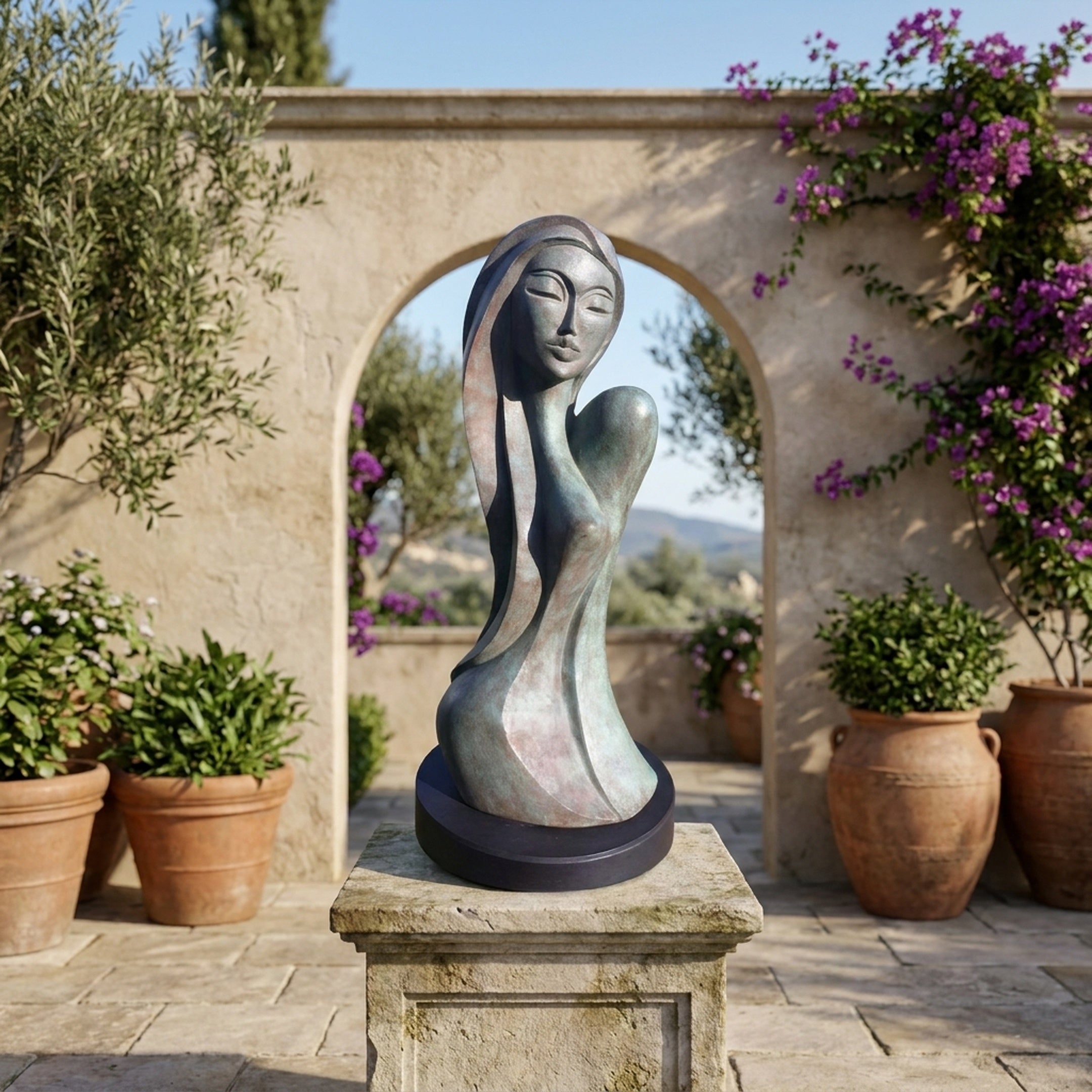 Modern Elongated Female Bust Bronze Sculpture by Giant Sculptures with verdigris patina, displayed on a stone pedestal in a Mediterranean courtyard with bougainvillea.