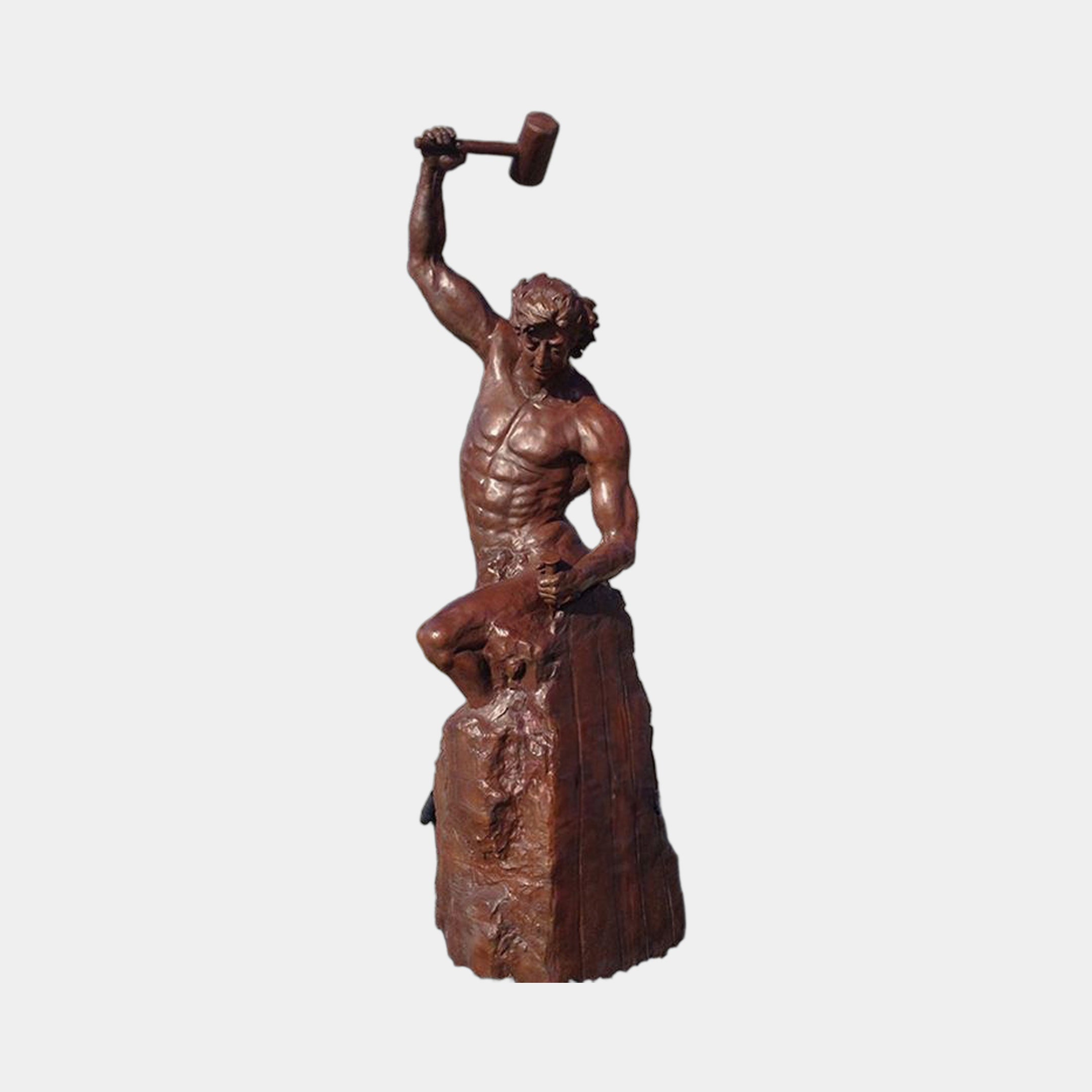 Monumental Classical Blacksmith Bronze Sculpture by Giant Sculptures, 240cm, bare-chested male figure raising a mallet overhead on a rocky base, warm reddish-brown patina.