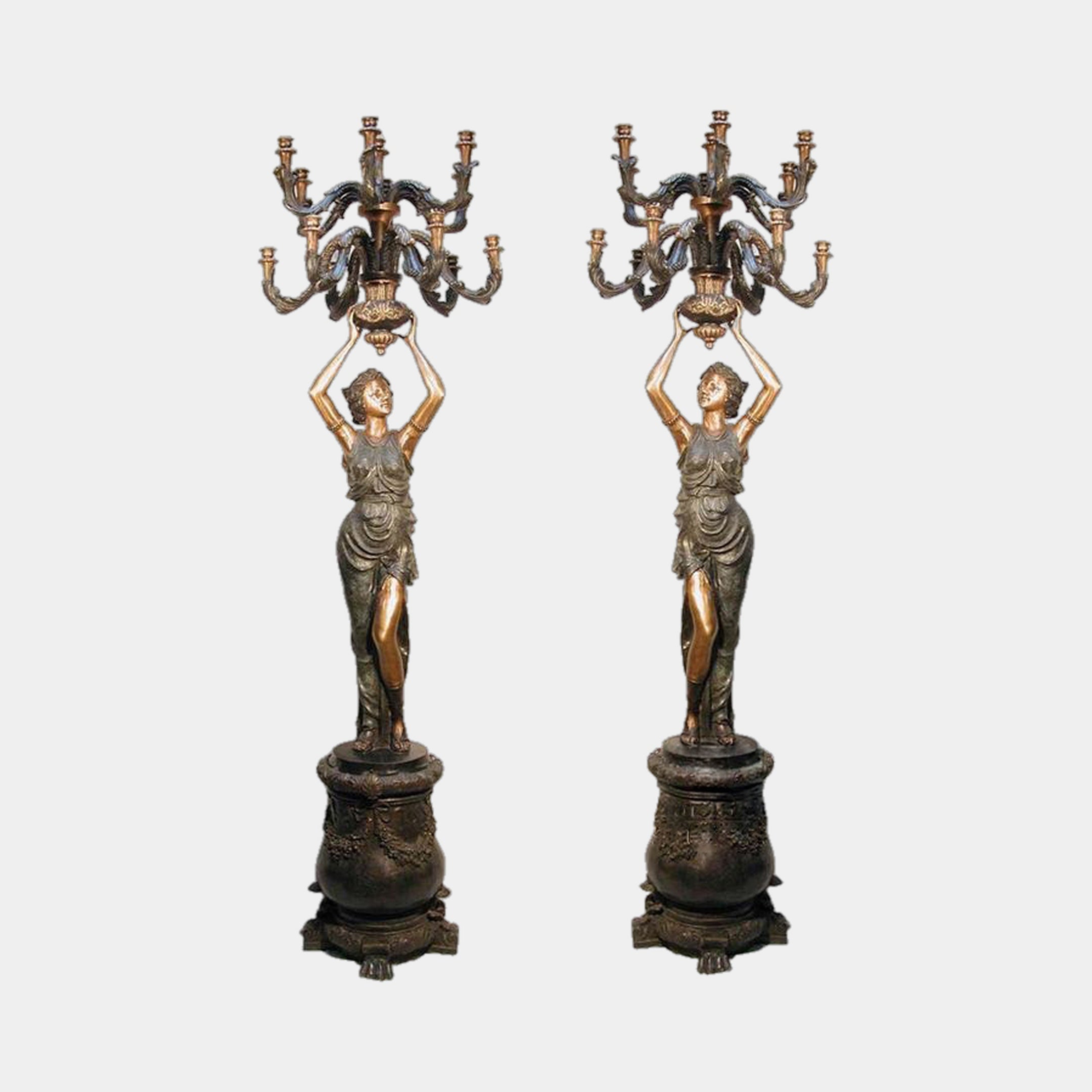 Monumental Classical Goddess Candelabra Bronze Sculpture Pair by Giant Sculptures, two-tone gold and black robed figures holding nine-arm candelabra on pedestals.