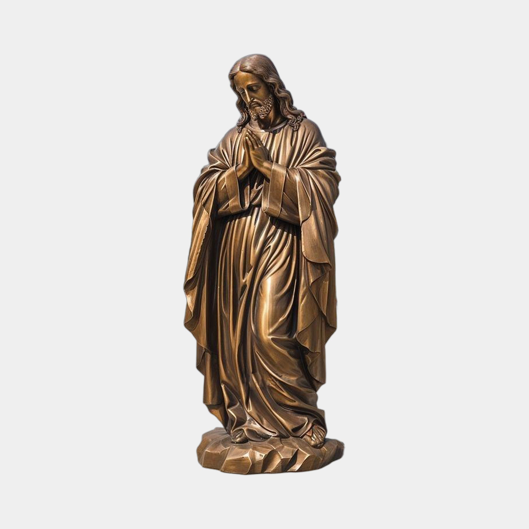 Monumental Classical Praying Jesus Figure Bronze Sculpture by Giant Sculptures, head bowed with hands clasped in prayer, draped robes on a faceted base.